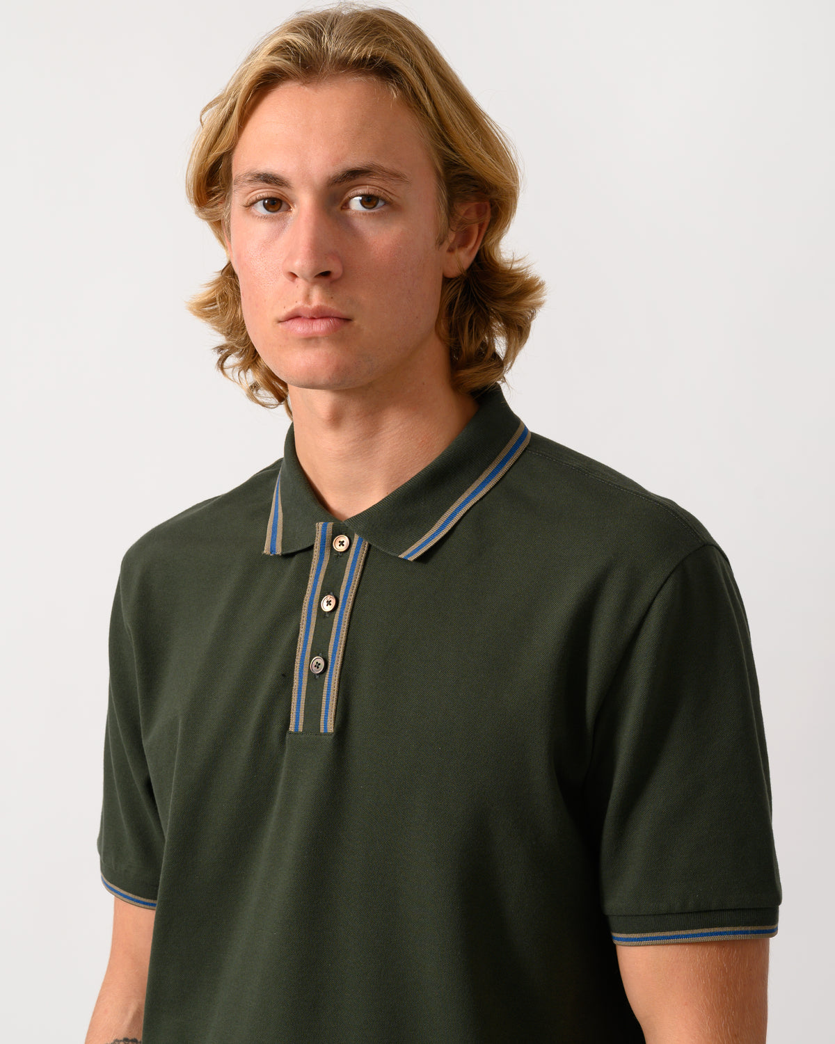 close upstudio photograph of a model wearing PS Paul Smith Mens Regular Fit Polo Shirt with Tipping in 38E Bottle Green