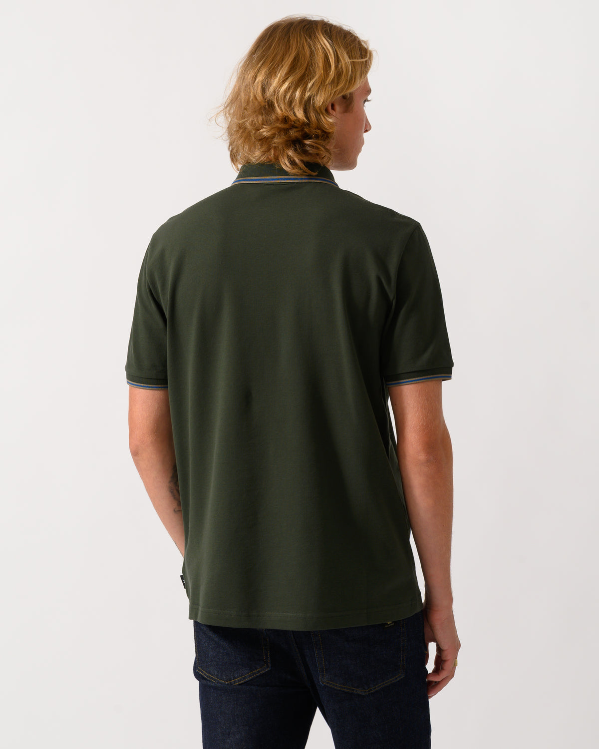 studio photograph showing back of a model wearing PS Paul Smith Mens Regular Fit Polo Shirt with Tipping in 38E Bottle Green