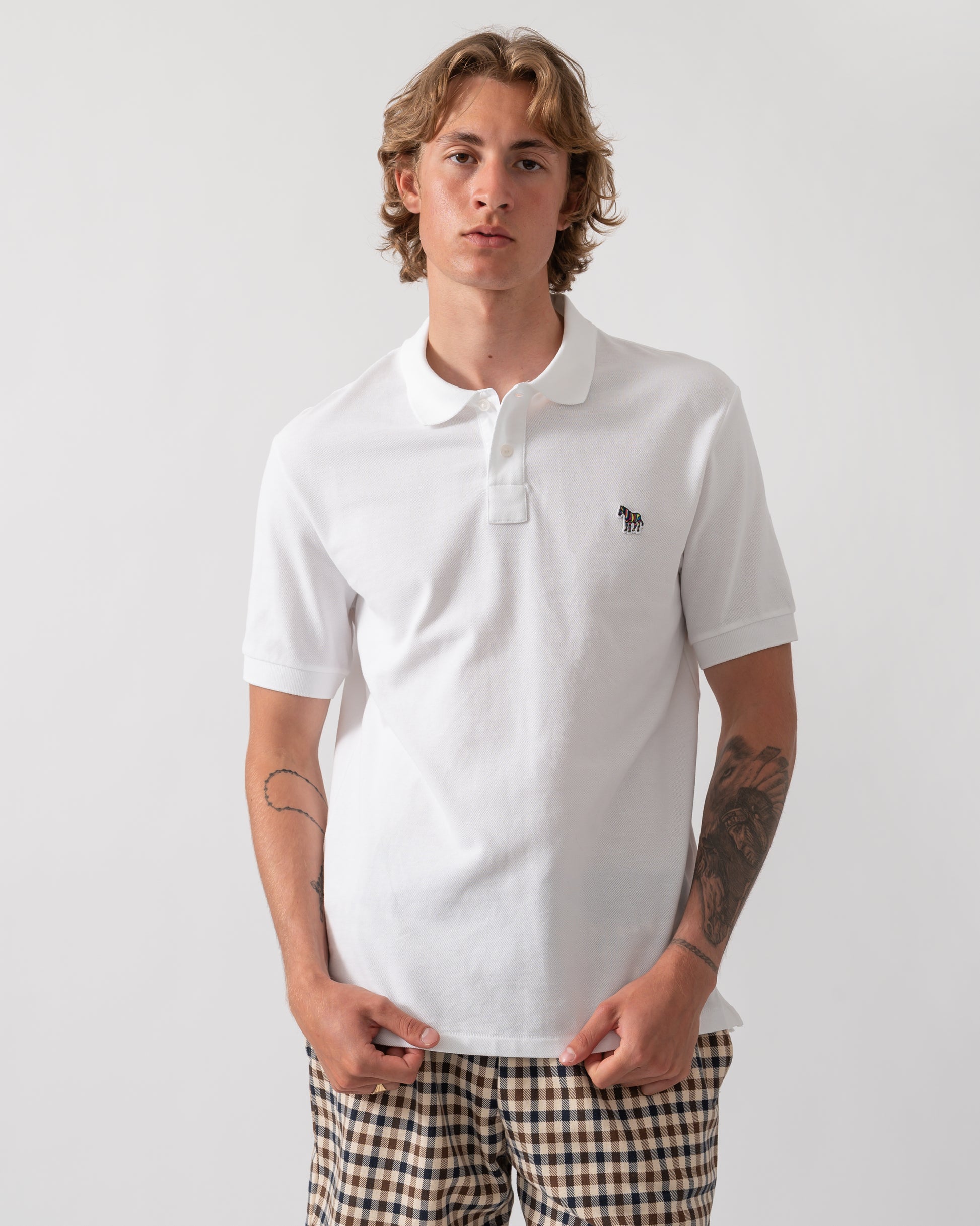 model wearing a PS Paul Smith Mens Regular Fit Short Sleeve Zebra Logo Polo Shirt M2R-183K-WZEBRA in 01 White