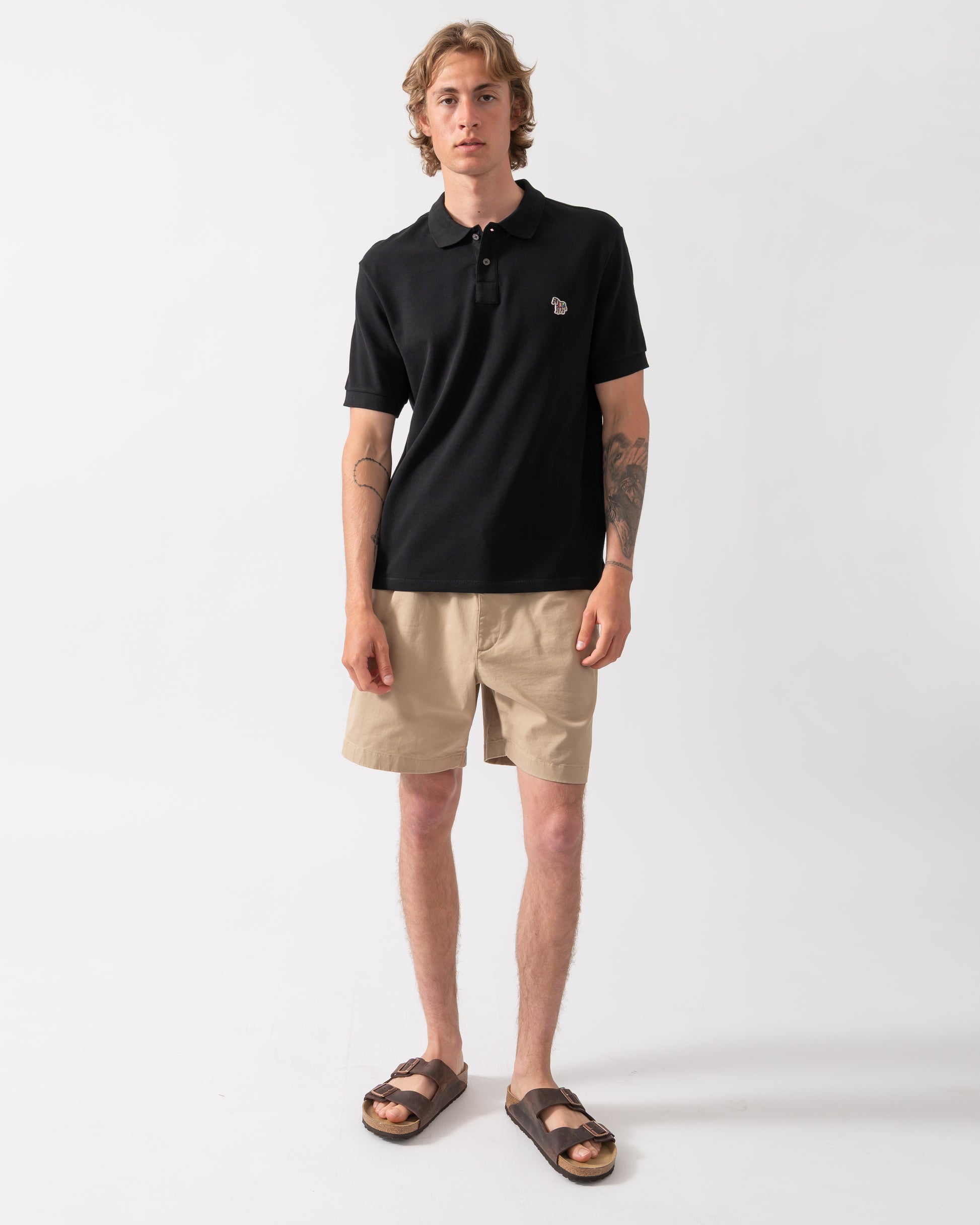full length shot of model wearing a PS Paul Smith Mens Regular Fit Short Sleeve Zebra Logo Polo Shirt M2R-183K-WZEBRA in 79 Black