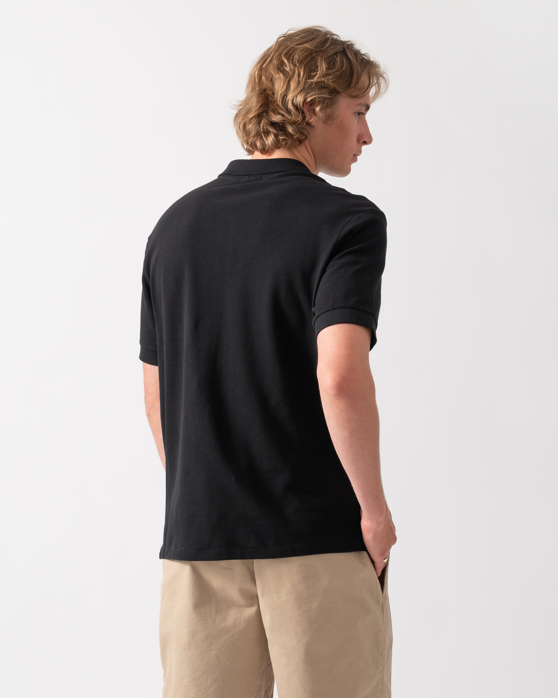 back of model wearing a PS Paul Smith Mens Regular Fit Short Sleeve Zebra Logo Polo Shirt M2R-183K-WZEBRA in 79 Black