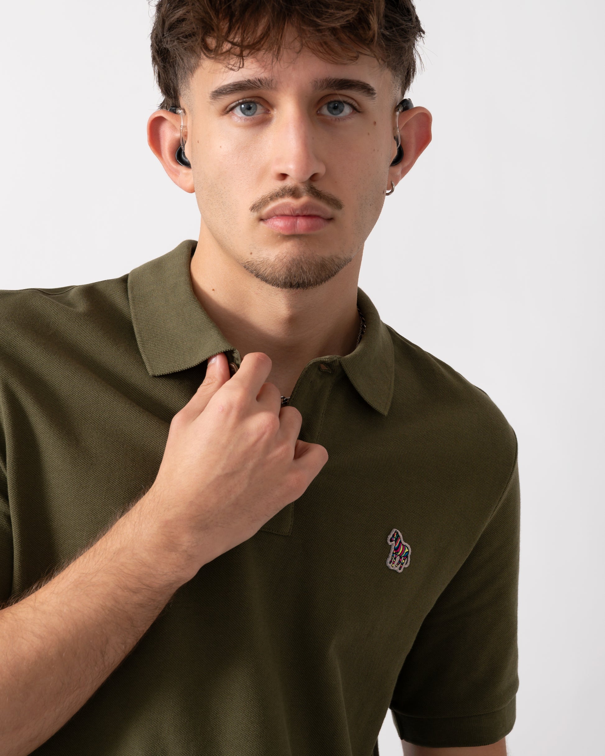Close up of a Model wearing a PS Paul Smith Mens Regular Fit Short Sleeve Zebra Polo Shirt in Green