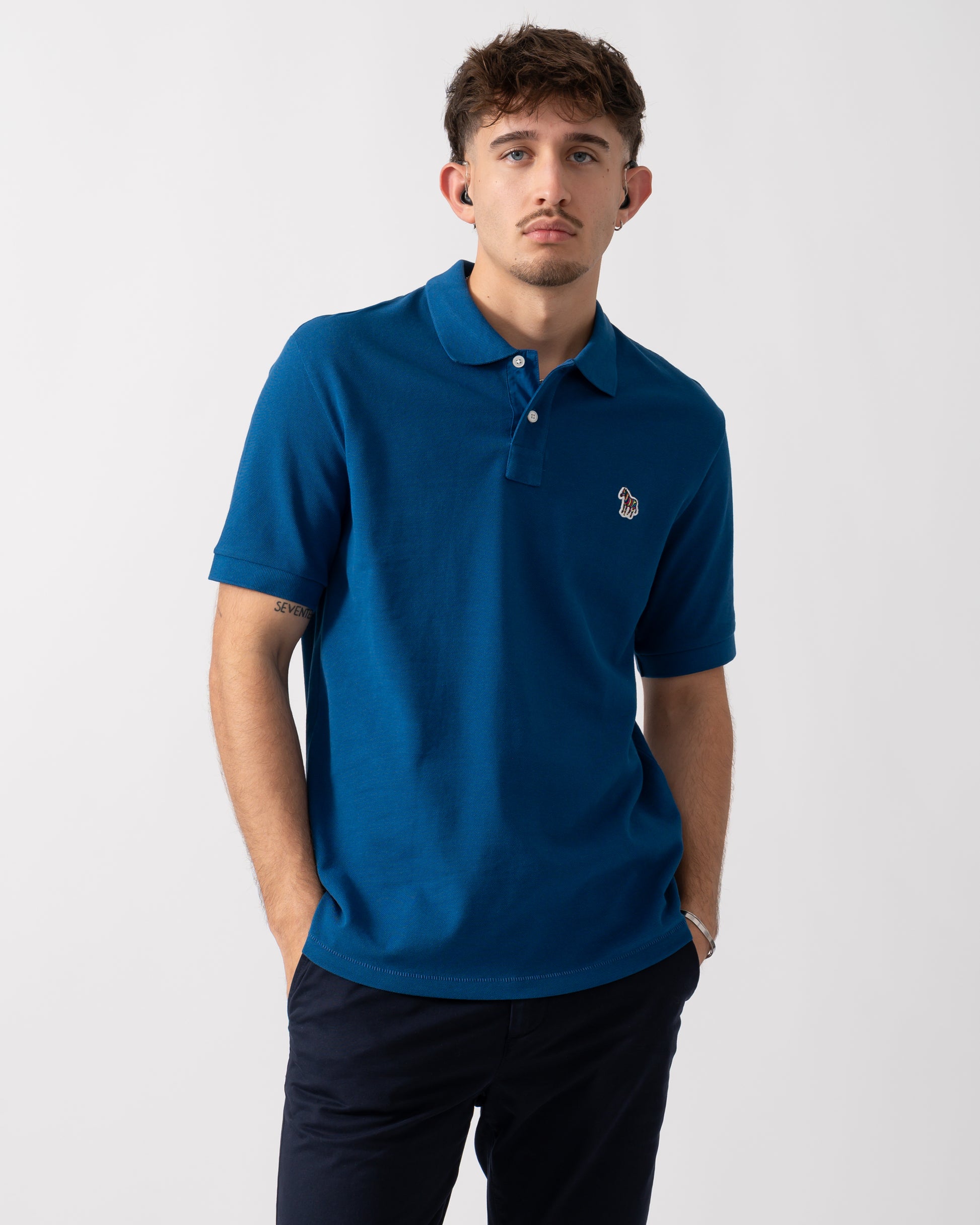 Model wearing a PS Paul Smith Mens Regular Fit Short Sleeve Zebra Polo Shirt in Blue