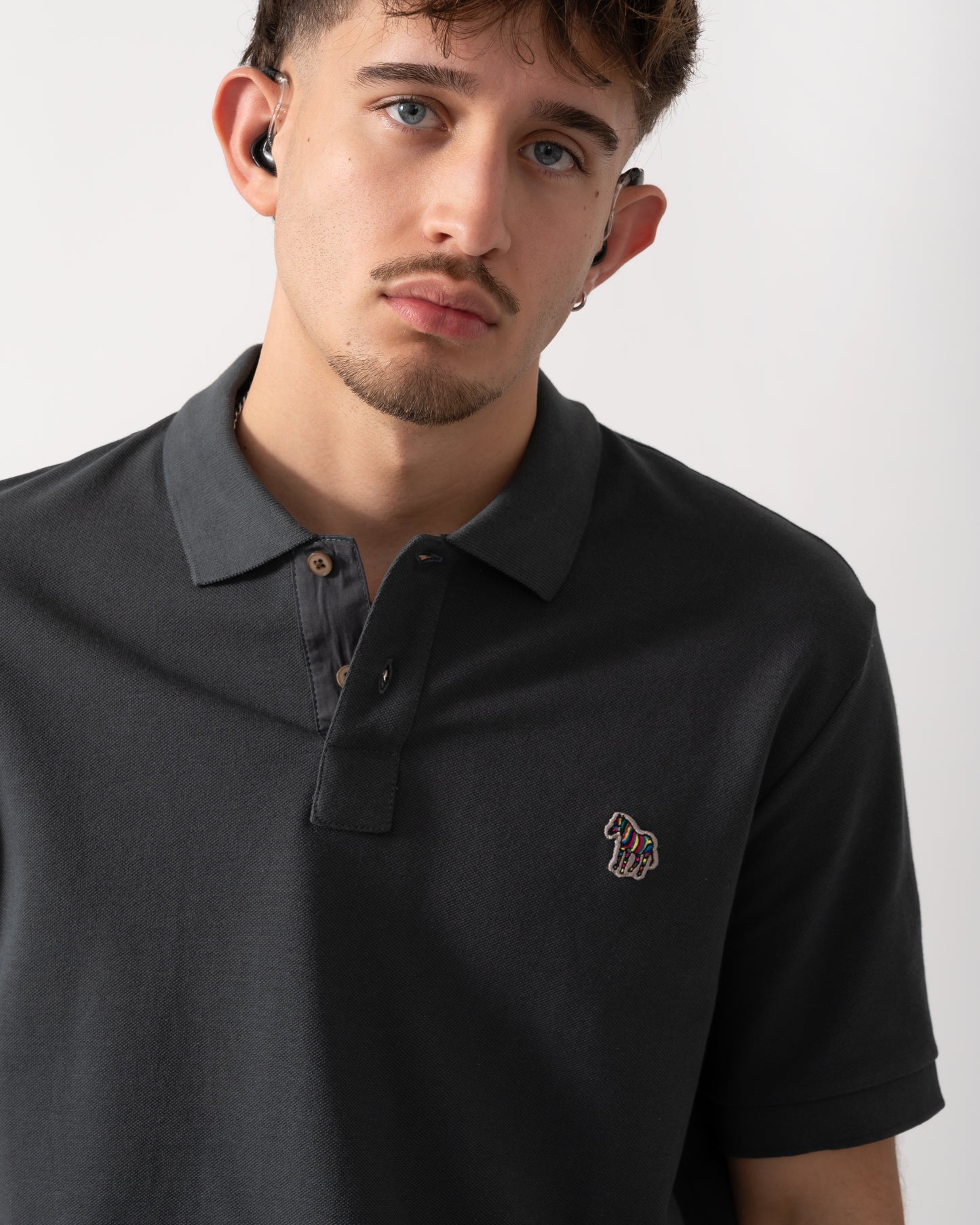 Close up shot of a Model wearing a PS Paul Smith Mens Regular Fit Short Sleeve Zebra Polo Shirt in Grey