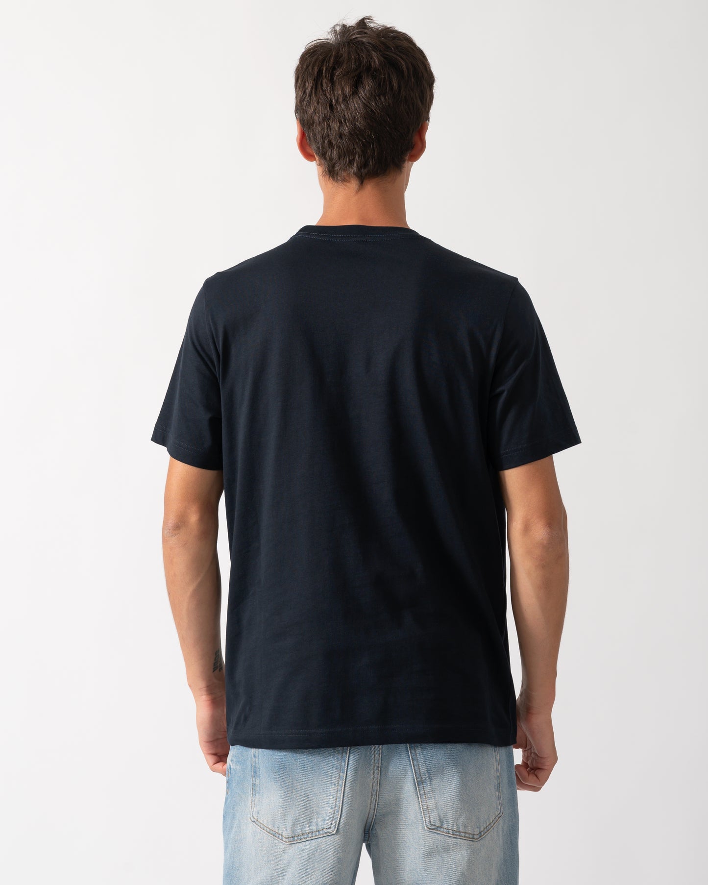 back a model wearing a PS Paul Smith Mens Regular Fit Table Football Graphic T-Shirt in 49 Very Dark Navy