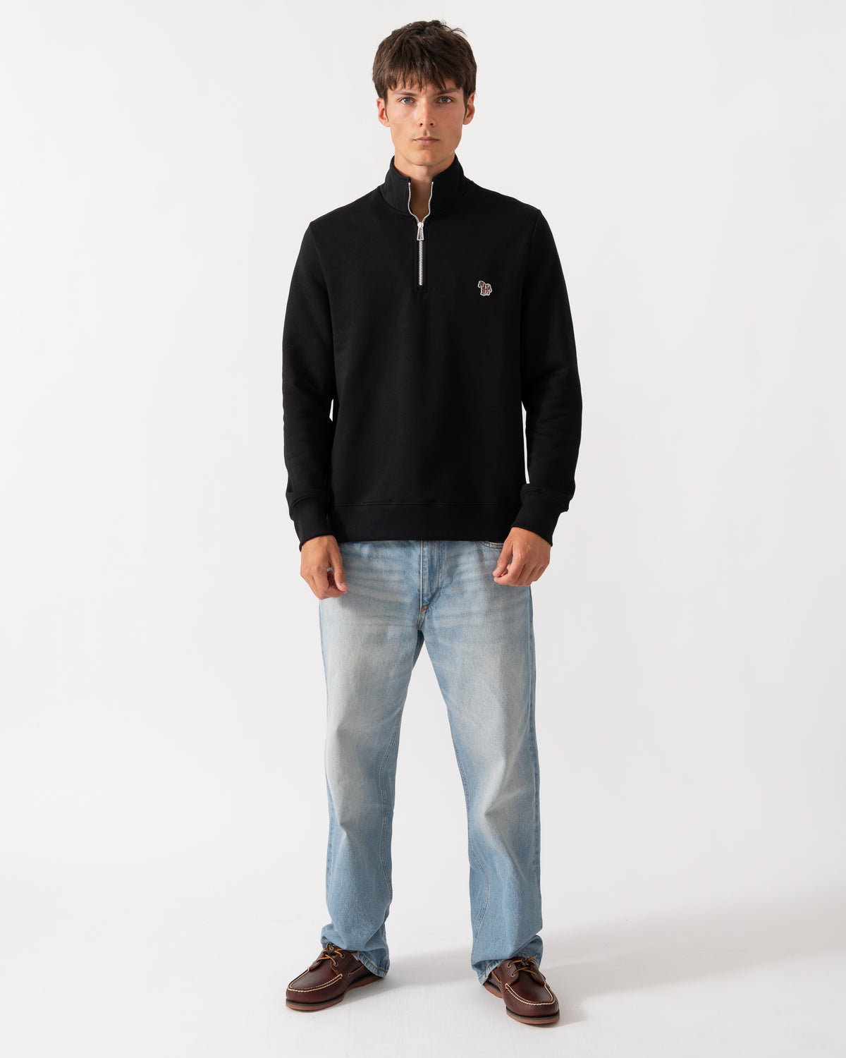 full length of a model wearing a PS Paul Smith Mens Regular Fit Zebra Logo 1/4 Zip Top in 79 Black