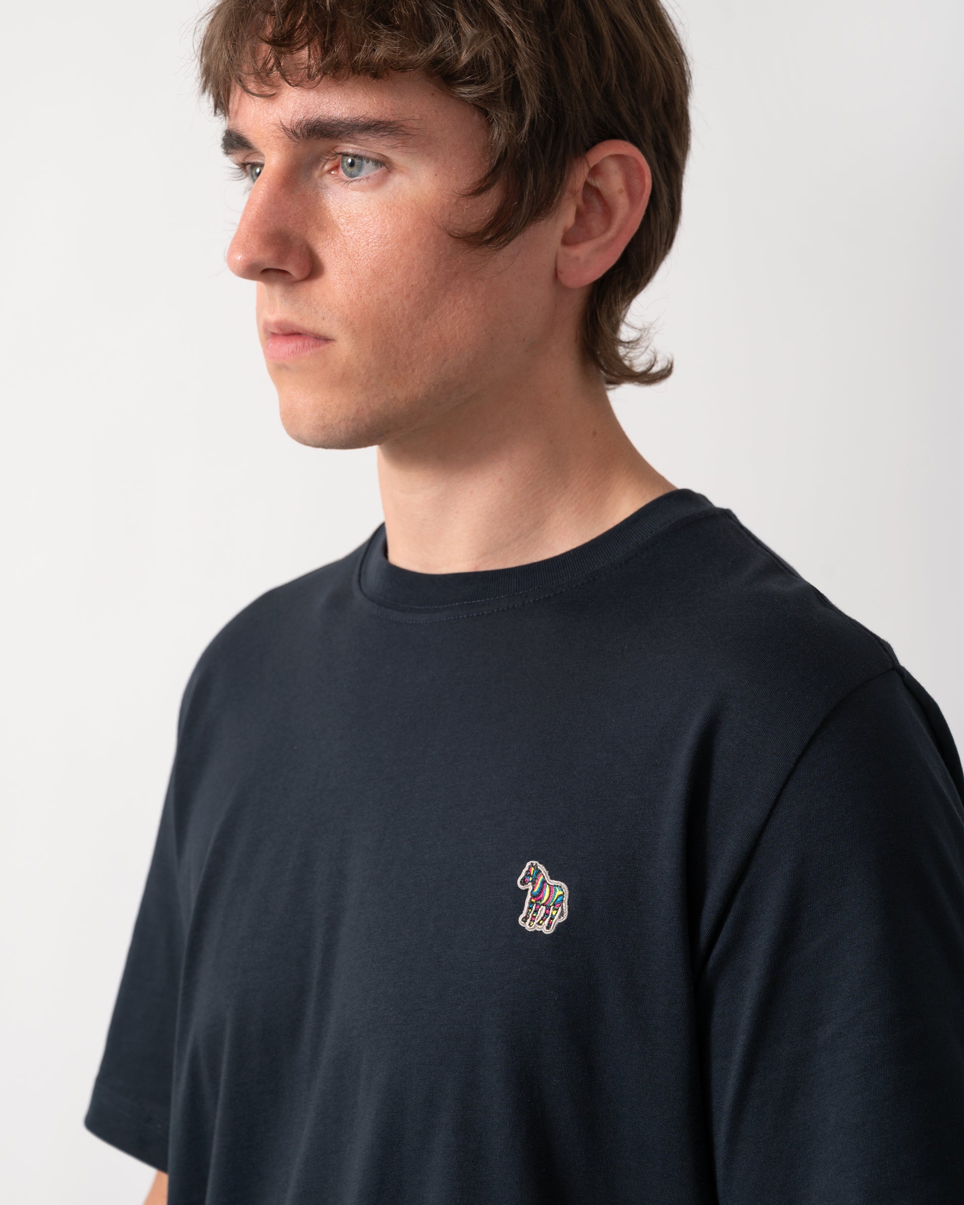 close up shot of a model wearing a PS Paul Smith Mens Regular Fit Zebra Logo T-Shirt M2R-011R-WZEBRA in 49 Very Dark Navy