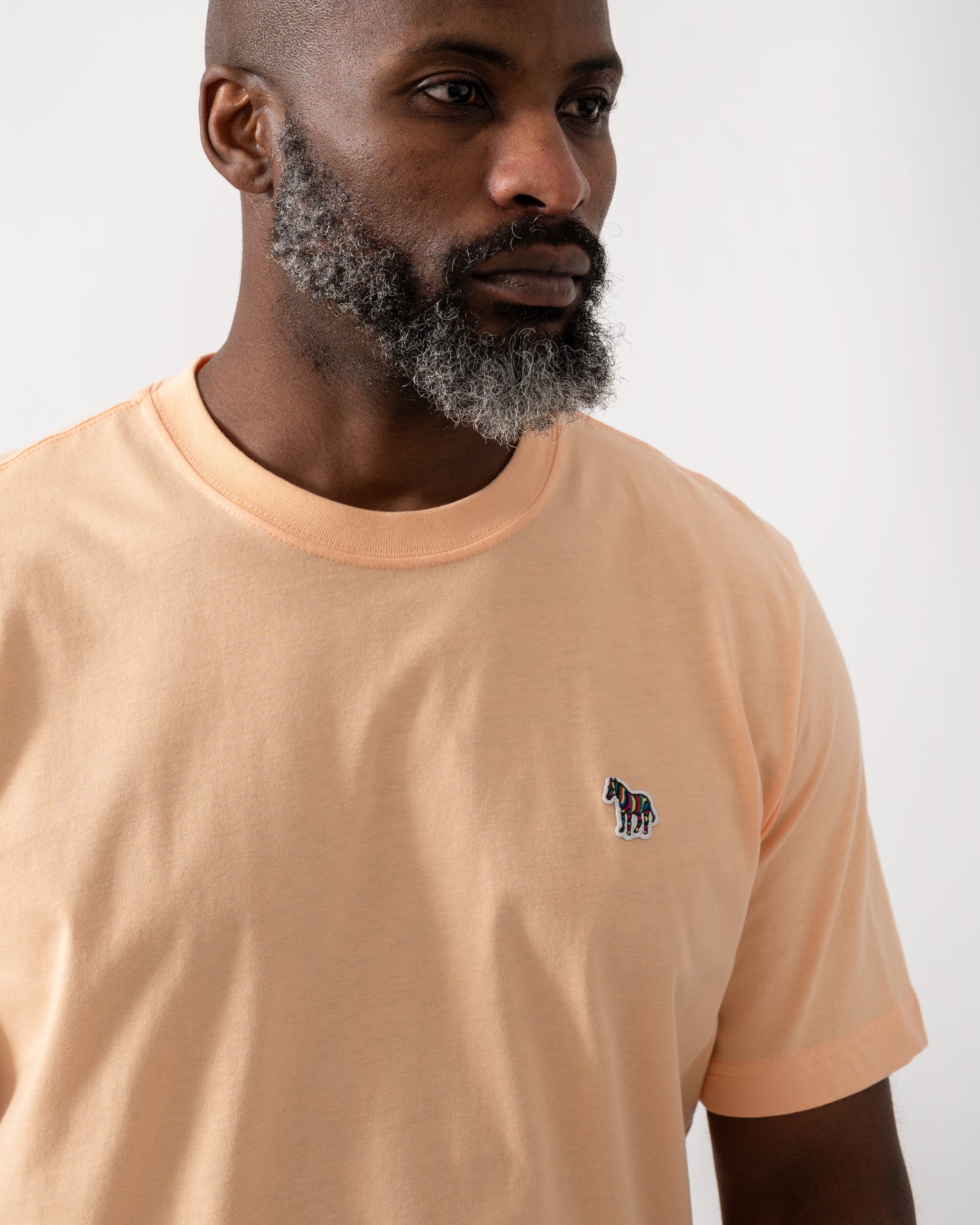 Detail shot of a Model wearing a PS Paul Smith Mens Short Sleeve Zebra Graphic T-Shirt in Orange