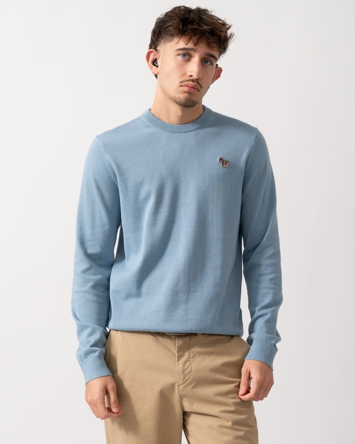 Model wearing a PS Paul Smith Mens Sweater  Zebra Badge Crew Neck Sweatshirt in Blue