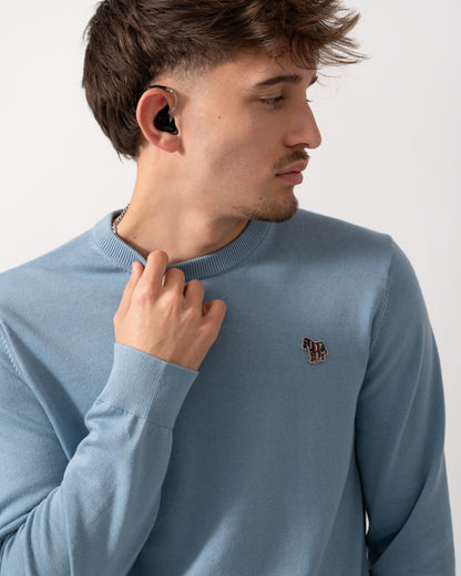 close up of aModel wearing a PS Paul Smith Mens Sweater  Zebra Badge Crew Neck Sweatshirt in Blue