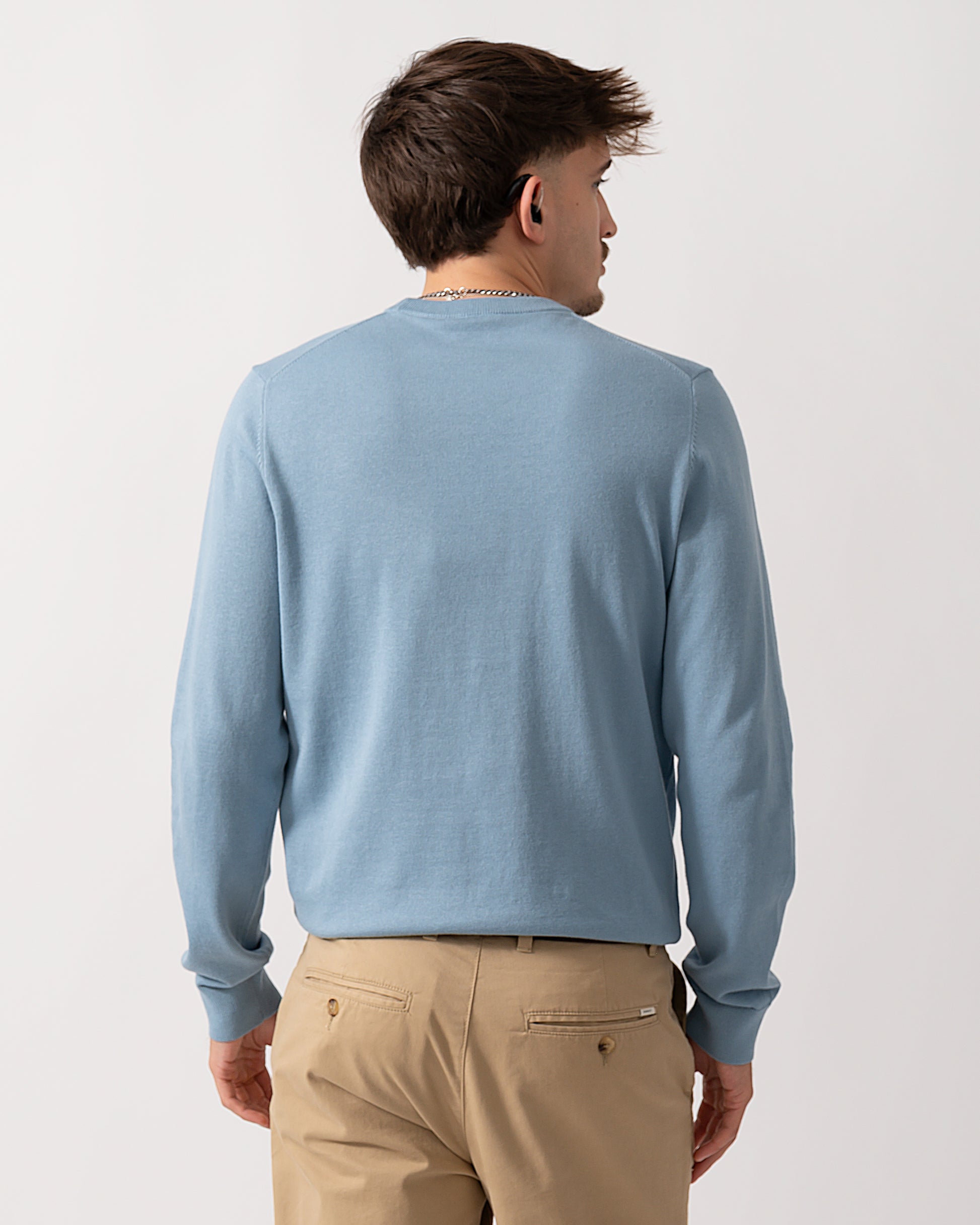 back shot of a Model wearing a PS Paul Smith Mens Sweater  Zebra Badge Crew Neck Sweatshirt in Blue