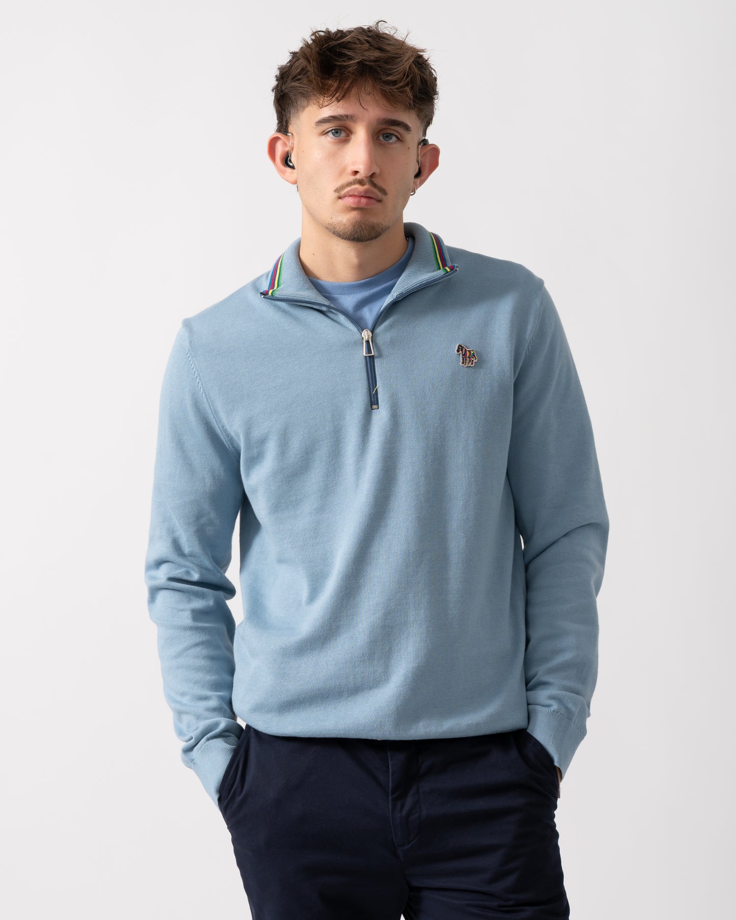 Model wearing a PS Paul Smith Mens Sweater Zip Neck Zebera Badge in Blue