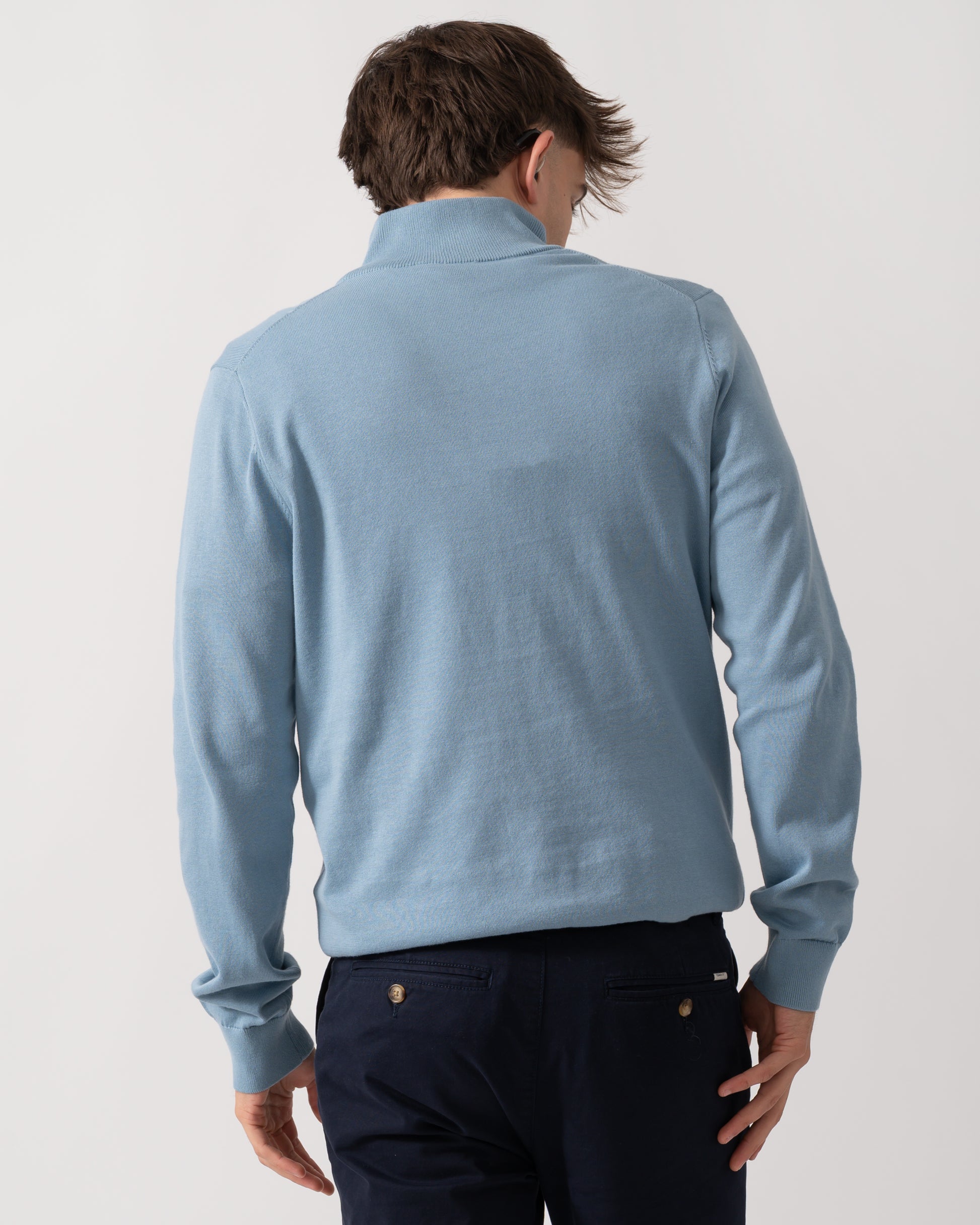 Back detail of a Model wearing a PS Paul Smith Mens Sweater Zip Neck Zebera Badge in Blue