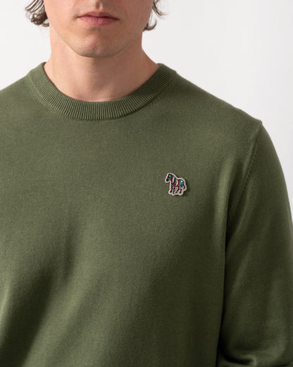 close up shot of a model wearing a PS Paul Smith Mens Zebra Badge Crew Neck Sweater in 35C Green
