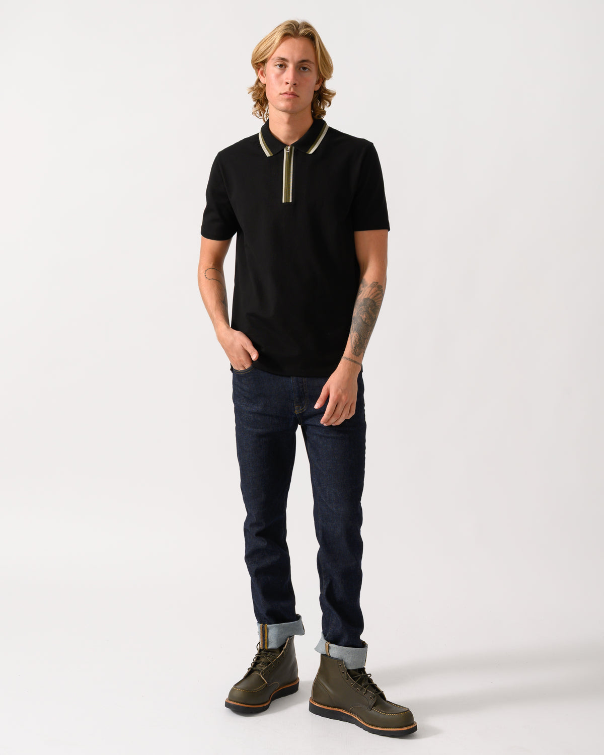 a full length studio photograph of a model wearing a PS Paul Smith Mens Zip Polo Shirt with Tipped Collar and Placket in 79 Black