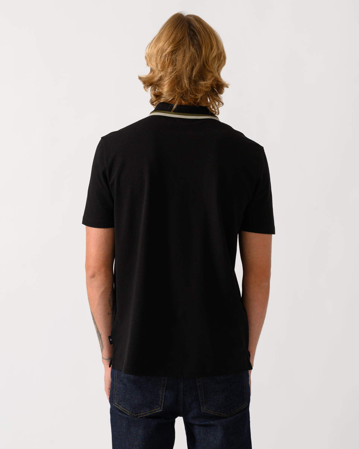 studio photograph of the back of a model wearing a PS Paul Smith Mens Zip Polo Shirt with Tipped Collar and Placket in 79 Black