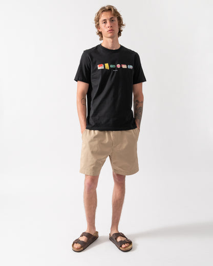 full length of model wearing a PS Paul Smith Mens "In A Row" Graphic T-Shirt in 79 Black 