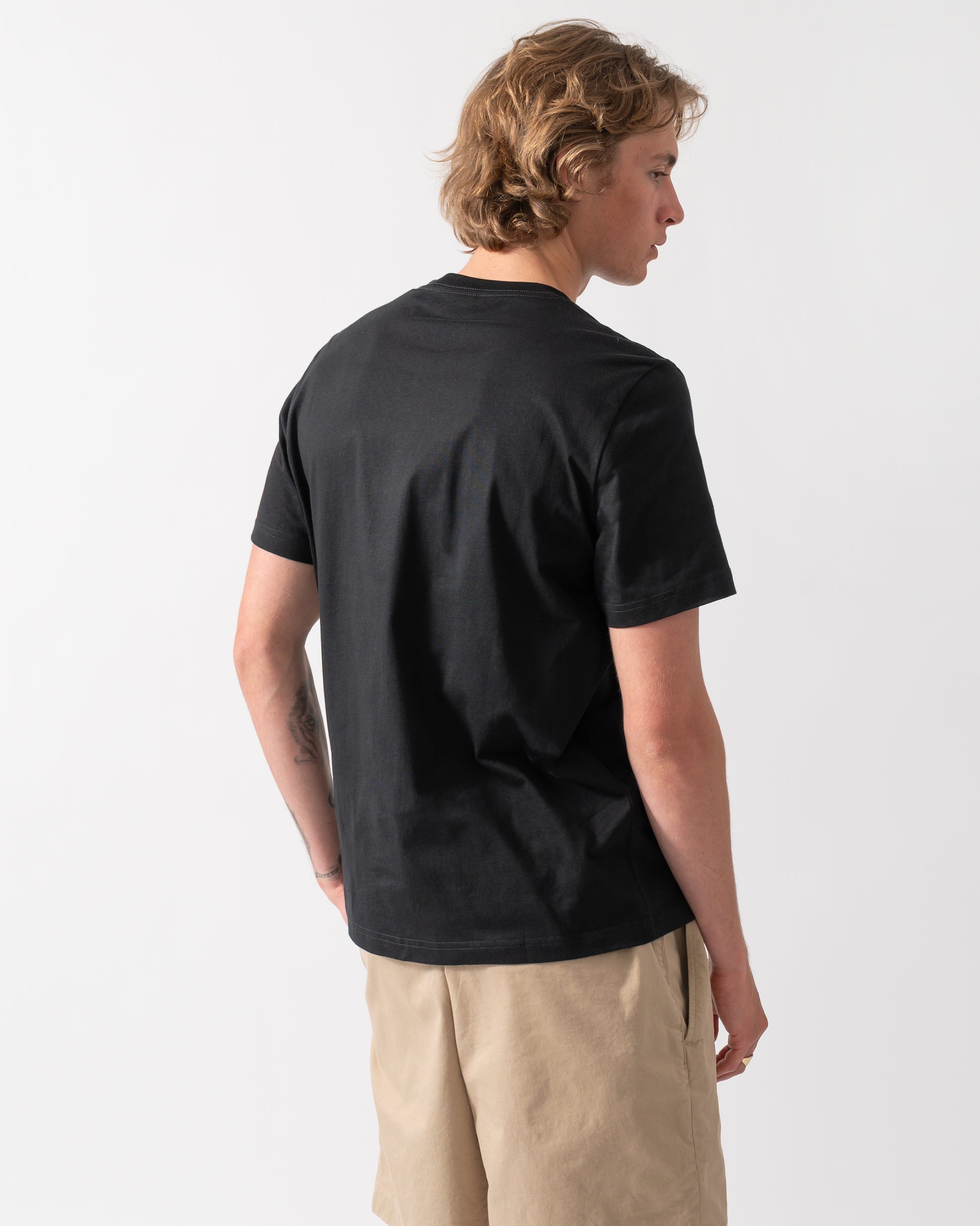 back of model wearing a PS Paul Smith Mens "In A Row" Graphic T-Shirt in 79 Black 