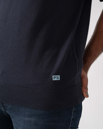Model wearing PS Paul Smith Mens Short Sleeve Knit Polo in 49 Blue - Patch detail