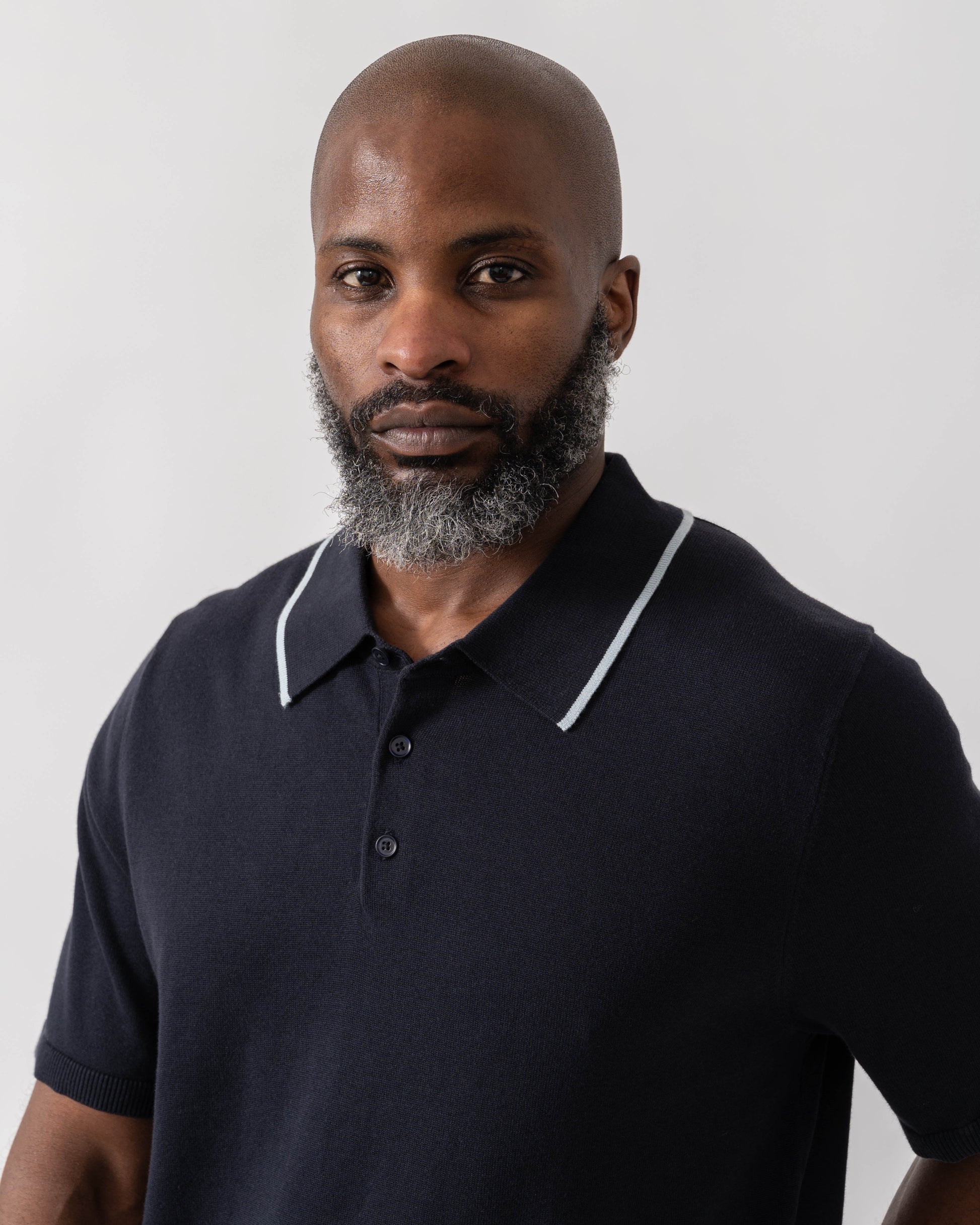 Model wearing PS Paul Smith Mens Short Sleeve Knit Polo in 49 Blue - Detail