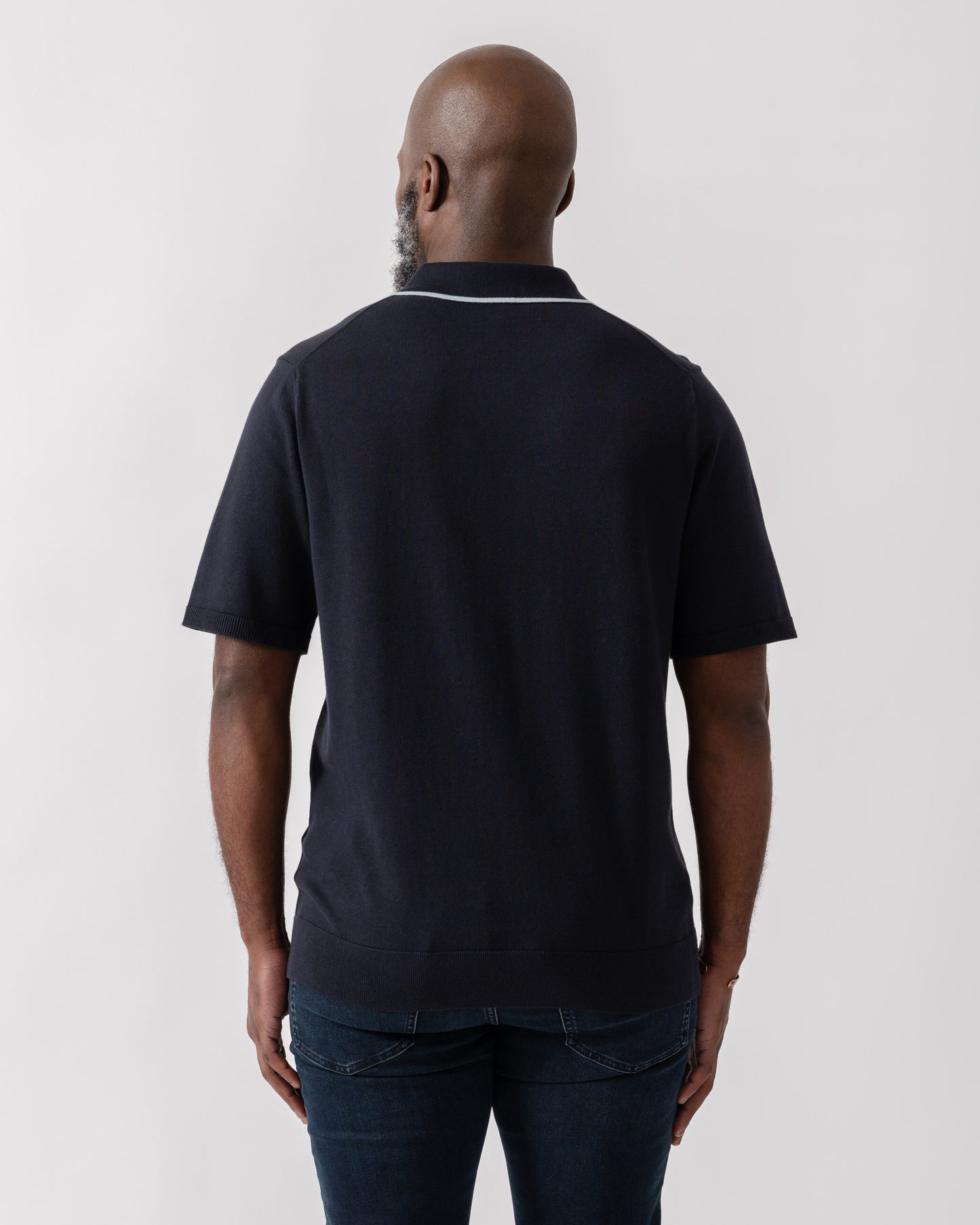 Model wearing PS Paul Smith Mens Short Sleeve Knit Polo in 49 Blue - back