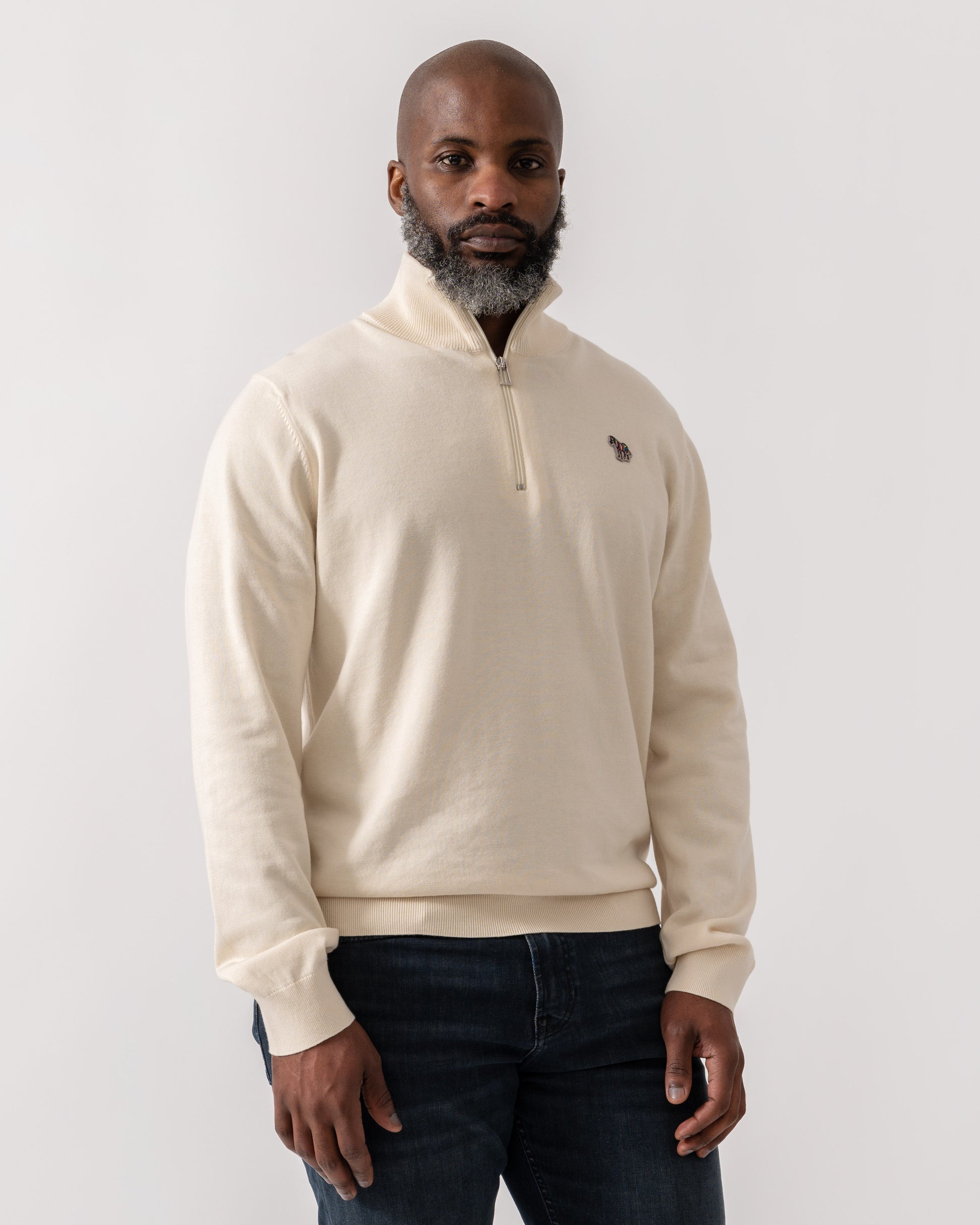 Model wearing PS Paul Smith Mens Zip Neck Zebra Badge Sweater in 04 White - Main