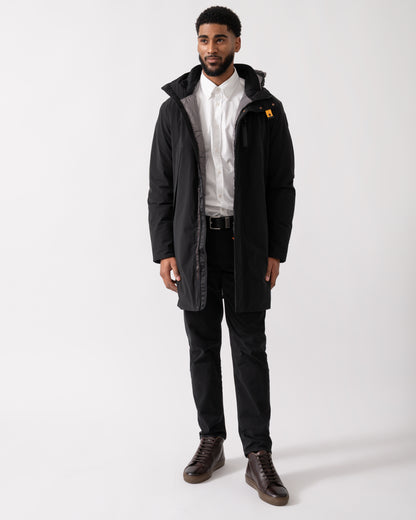 wide shot of a model wearing a Parajumpers Easy Mens Hooded Padded Coat in Black