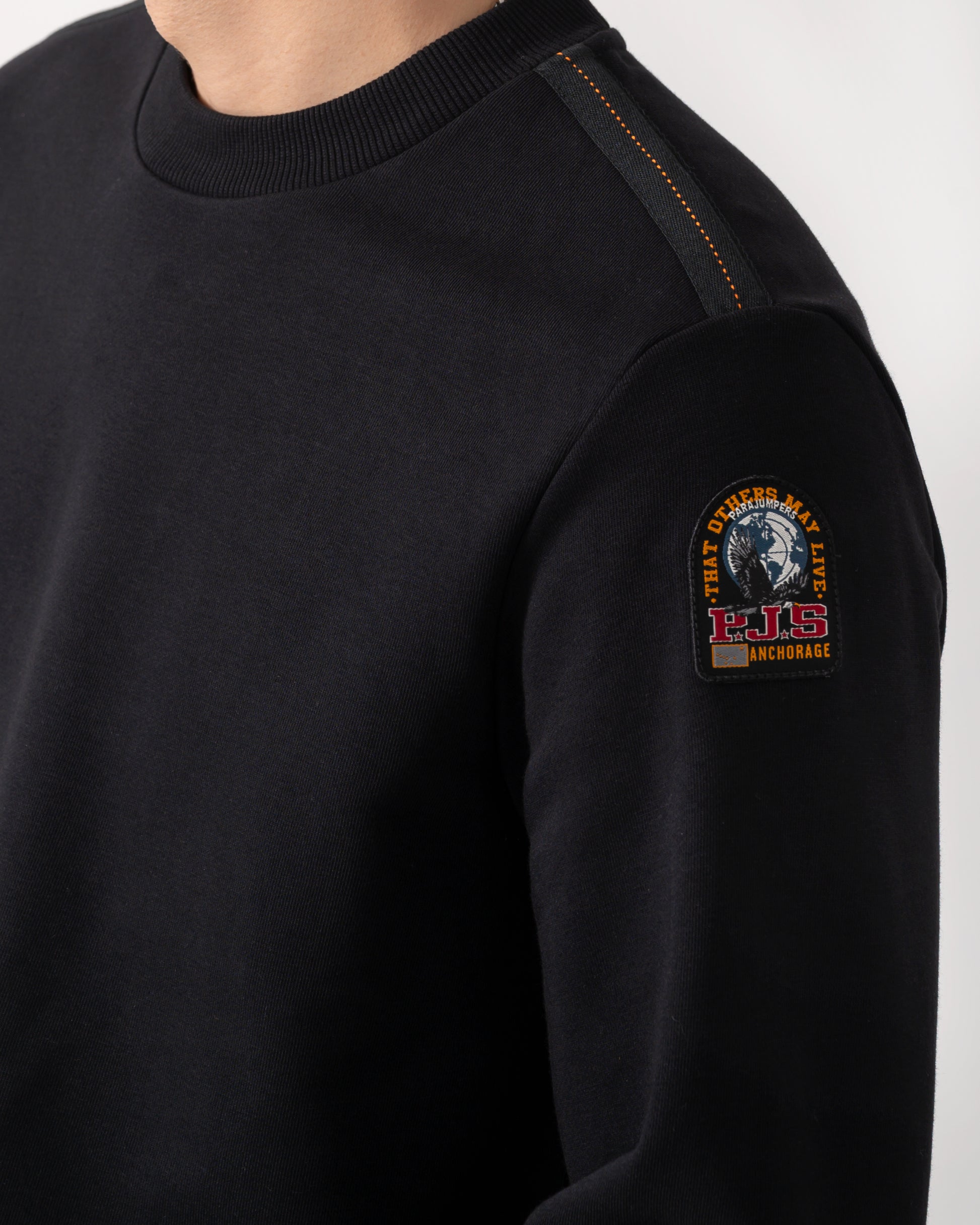 detail shot of a model wearing a Parajumpers K2 Crew Neck Mens Sweatshirt in Black 541