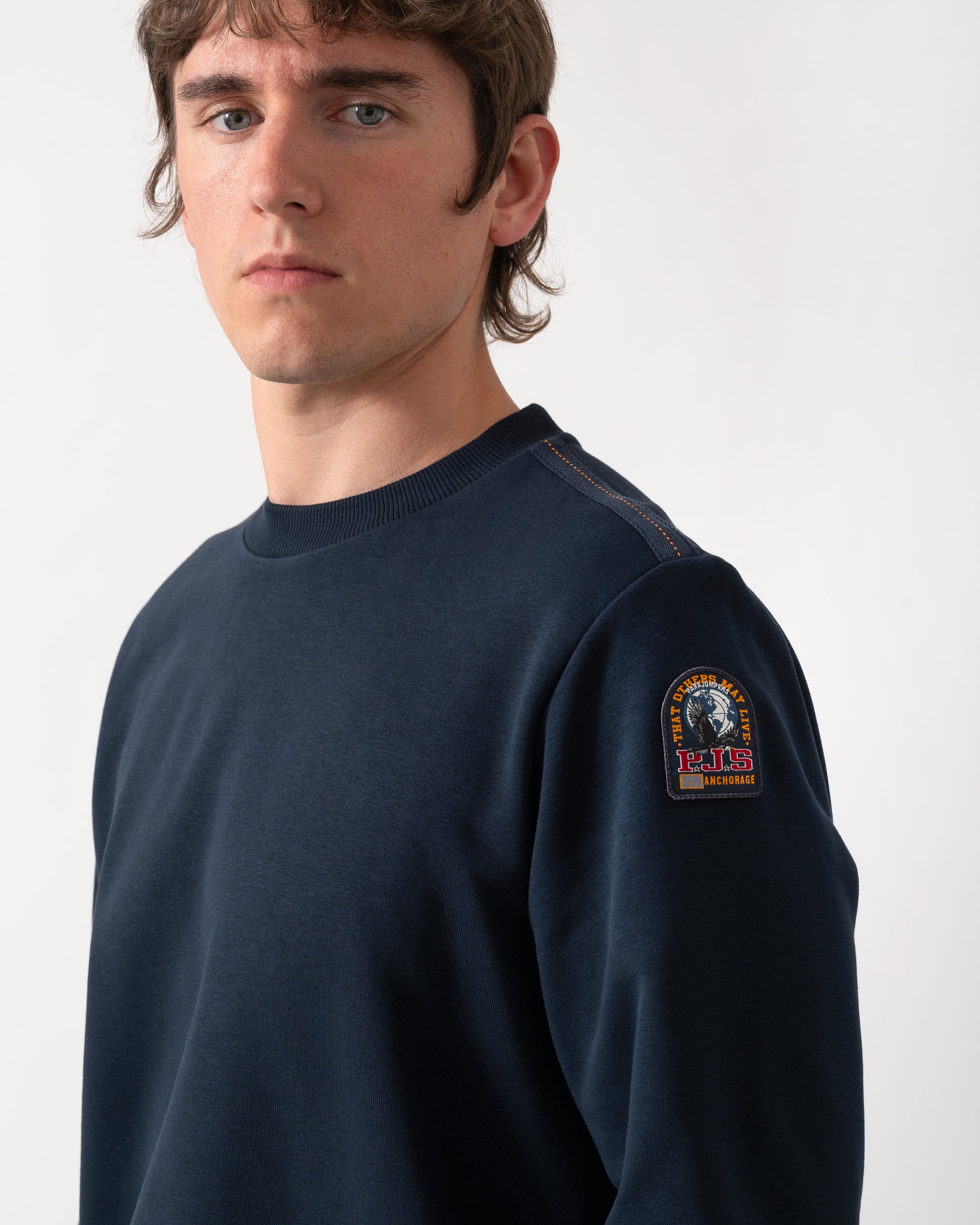 close up shot of a model wearing a Parajumpers K2 Crew Neck Mens Sweatshirt in Blue Navy 316