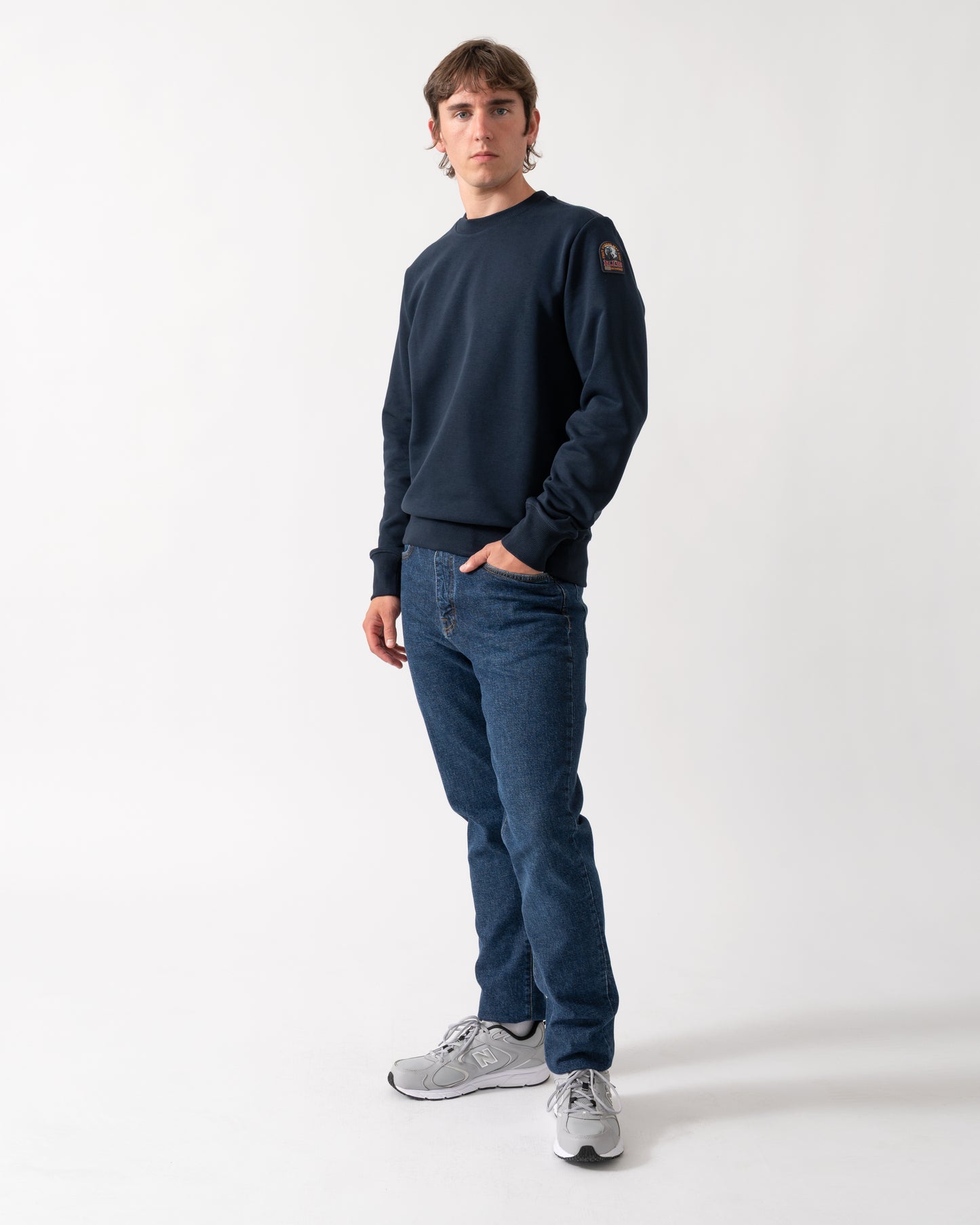 full length shot of a model wearing a Parajumpers K2 Crew Neck Mens Sweatshirt in Blue Navy 316