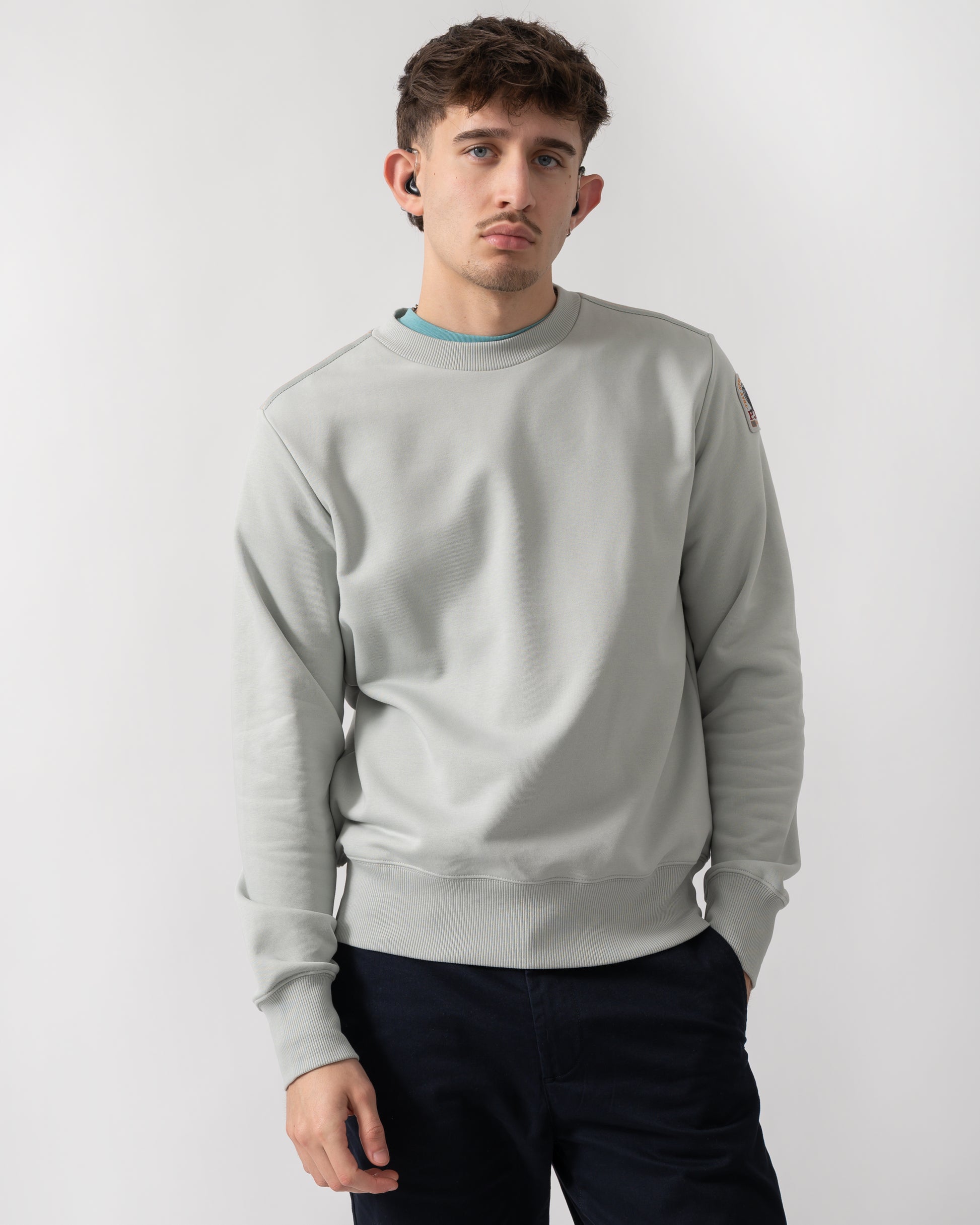studio shot of a model wearing a Parajumpers K2 Crew Neck Mens Sweatshirt in Fresh Grey 271