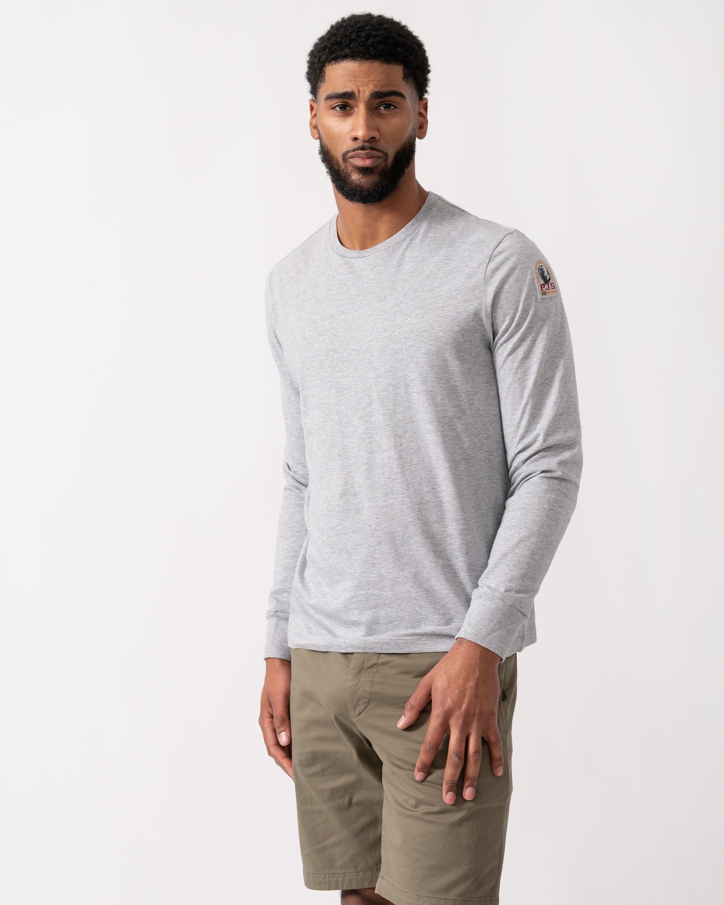 model wearing a Parajumpers Kip Mens Long Sleeve T-Shirt in Ash Grey Melange