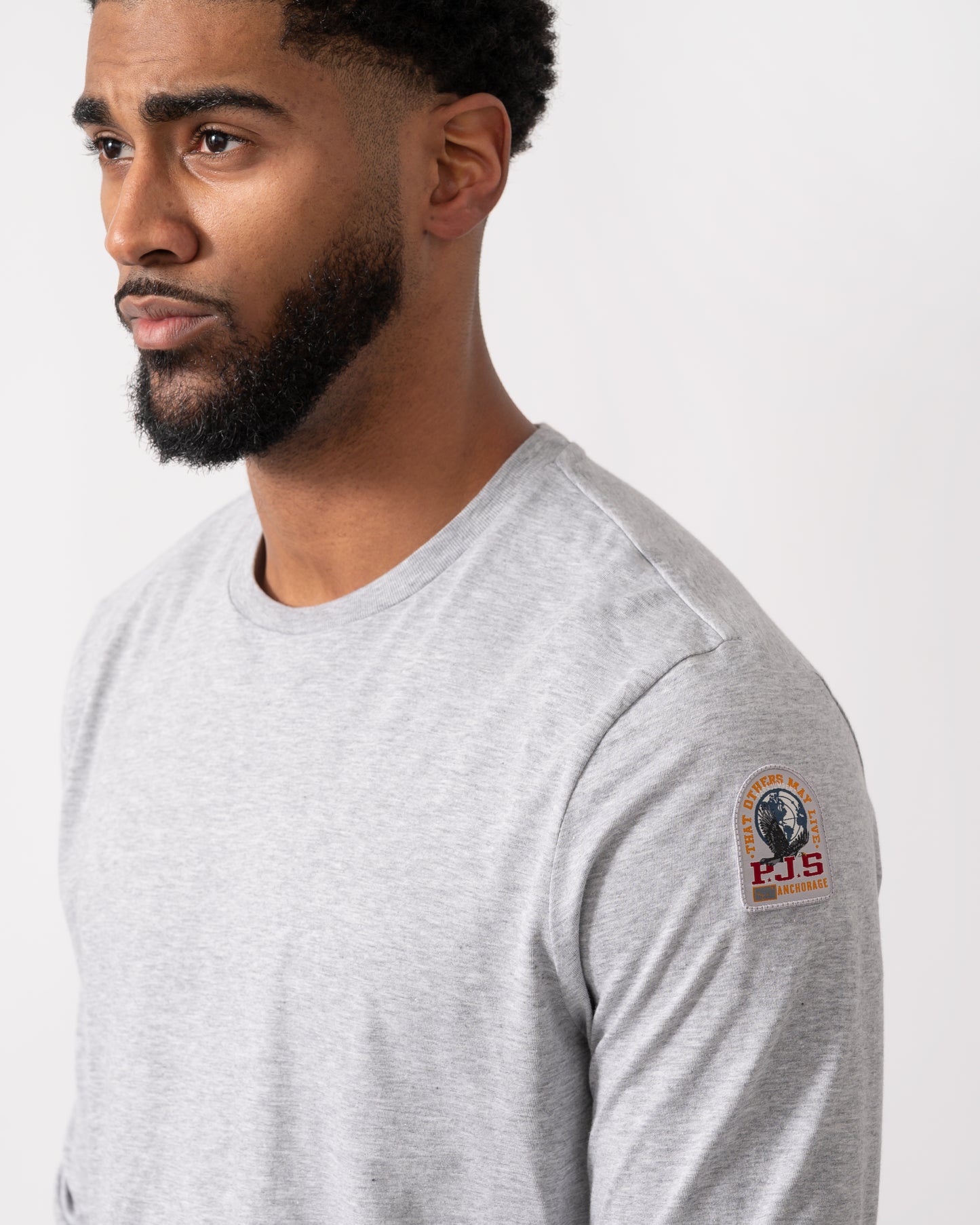 close up of a model wearing a Parajumpers Kip Mens Long Sleeve T-Shirt in Ash Grey Melange