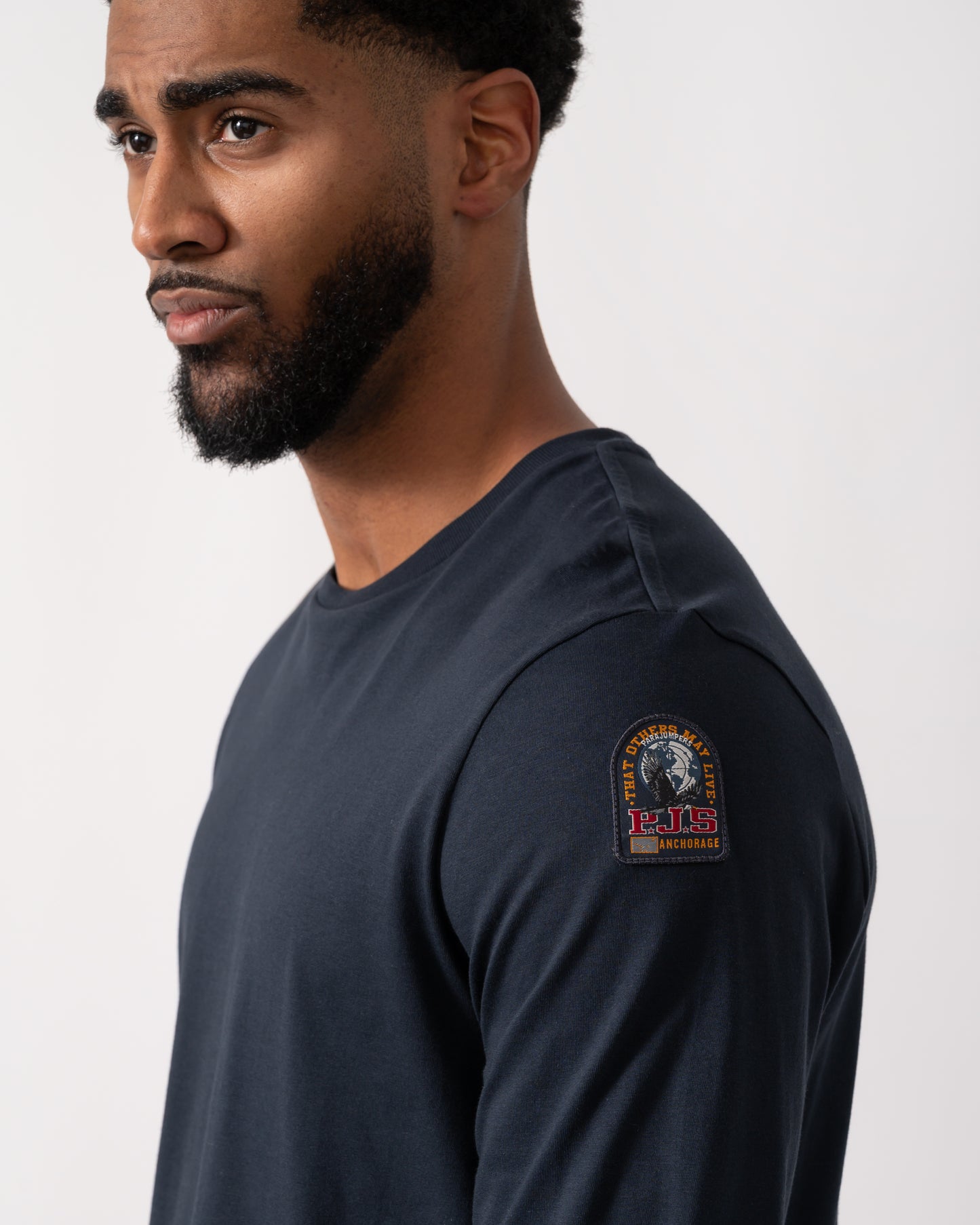 close up of a model wearing a Parajumpers Kip Mens Long Sleeve T-Shirt in Blue Navy