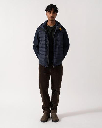full length Studio photograph of a model wearing a Parajumpers Nolan Mens Hybrid Hooded Jacket in Blue Navy 316