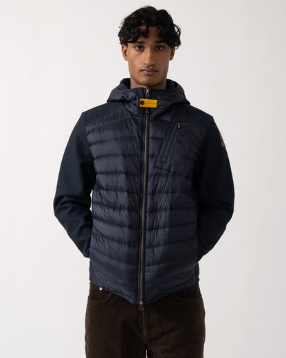 Studio photograph of a model wearing a Parajumpers Nolan Mens Hybrid Hooded Jacket in Blue Navy 316