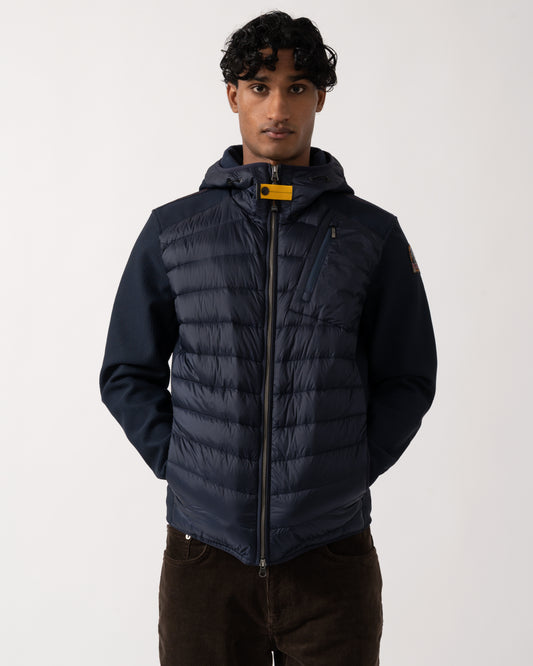 Studio photograph of a model wearing a Parajumpers Nolan Mens Hybrid Hooded Jacket in Blue Navy 316