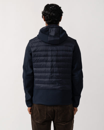 Studio photograph showing the back of a model wearing a Parajumpers Nolan Mens Hybrid Hooded Jacket in Blue Navy 316