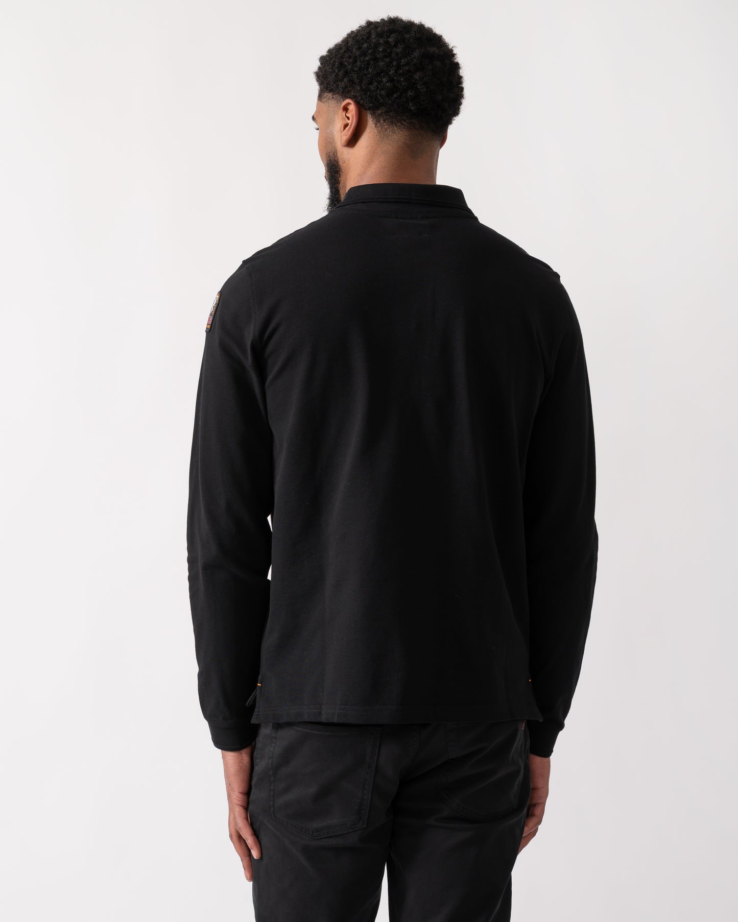 back shot of a Model wearing a Parajumpers Oberon Polo Mens Polo in Black