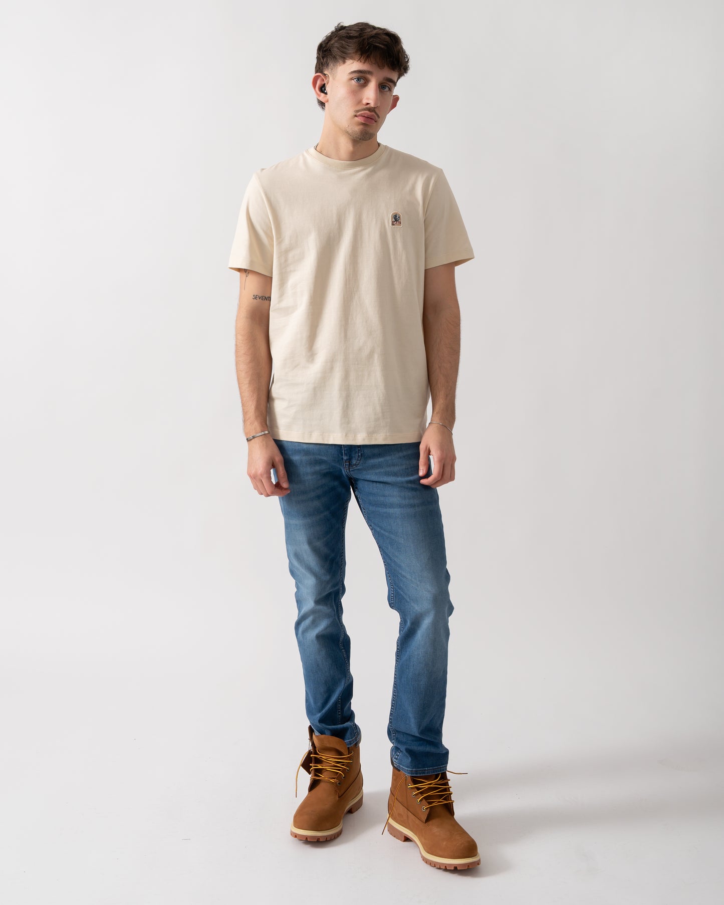 full length shot of a model wearing a Parajumpers Patch Mens T-Shirt in Bone 266