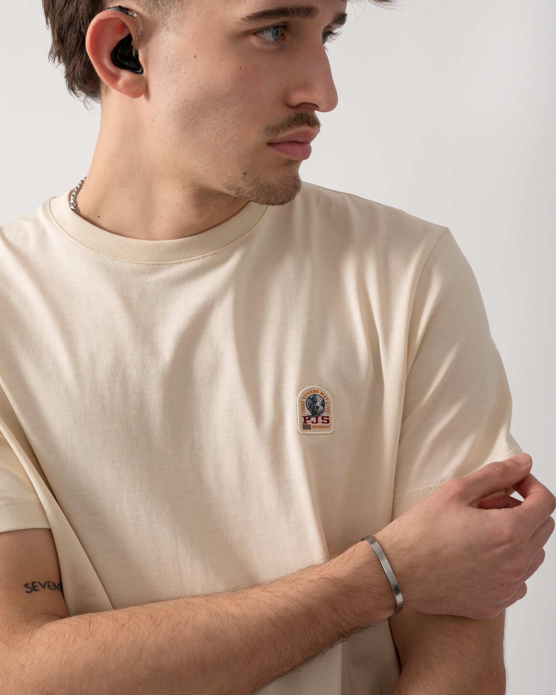 close up shot of a model wearing a Parajumpers Patch Mens T-Shirt in Bone 266