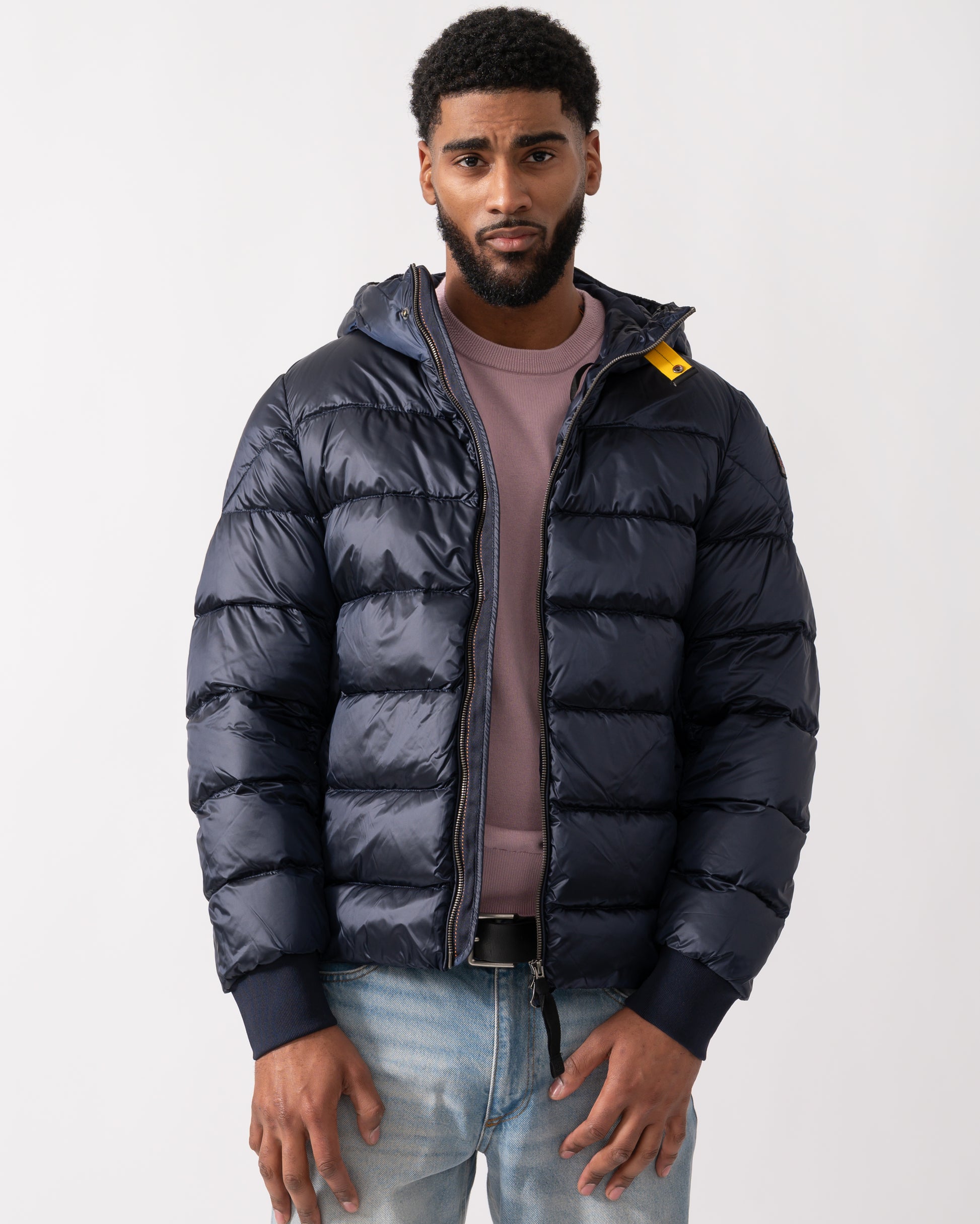 model wearing a Parajumpers Pharrell Mens Hooded Down Bomber in Blue Navy