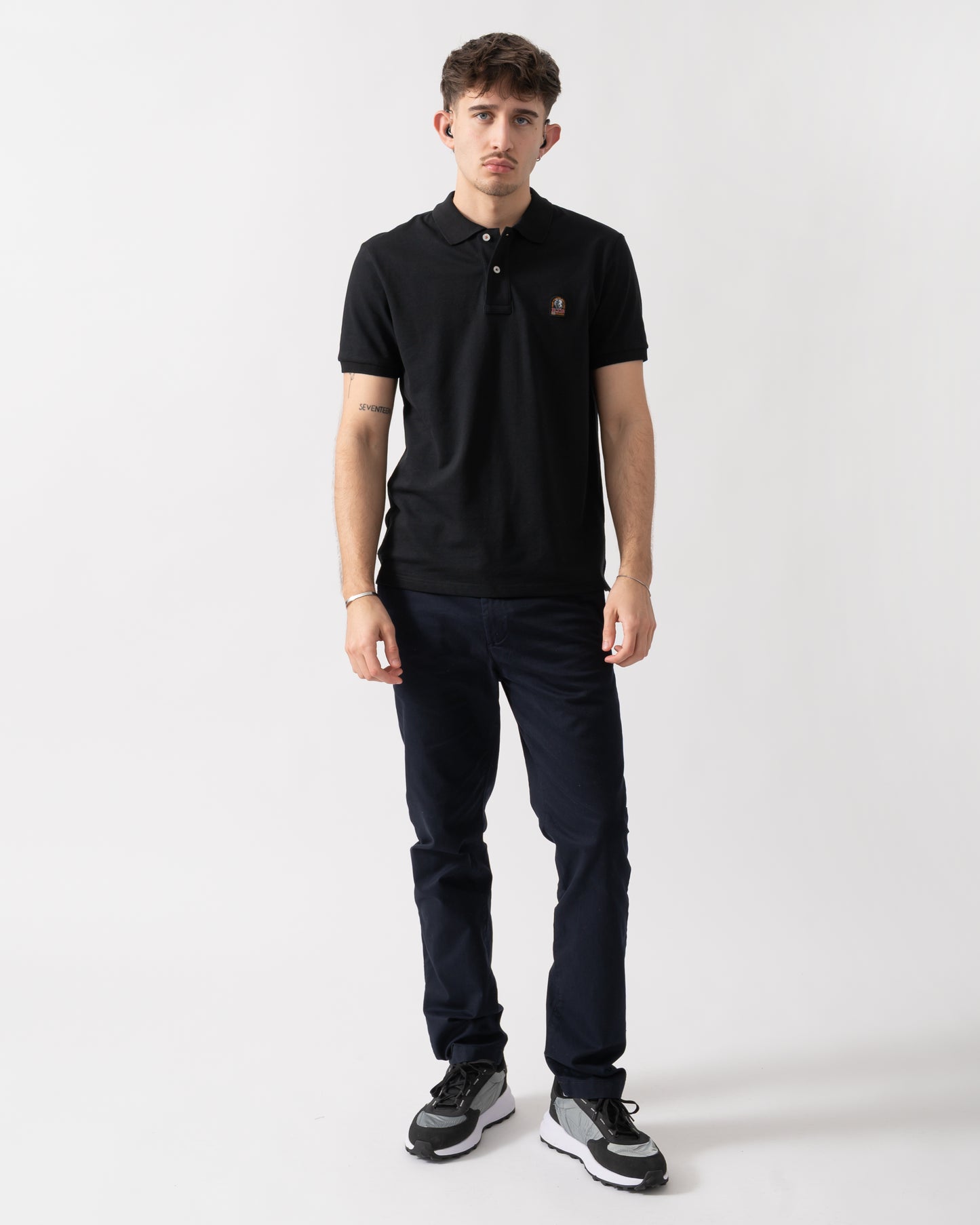 full length shot of a model wearing a Parajumpers Wellington Mens Polo Shirt in Black 541