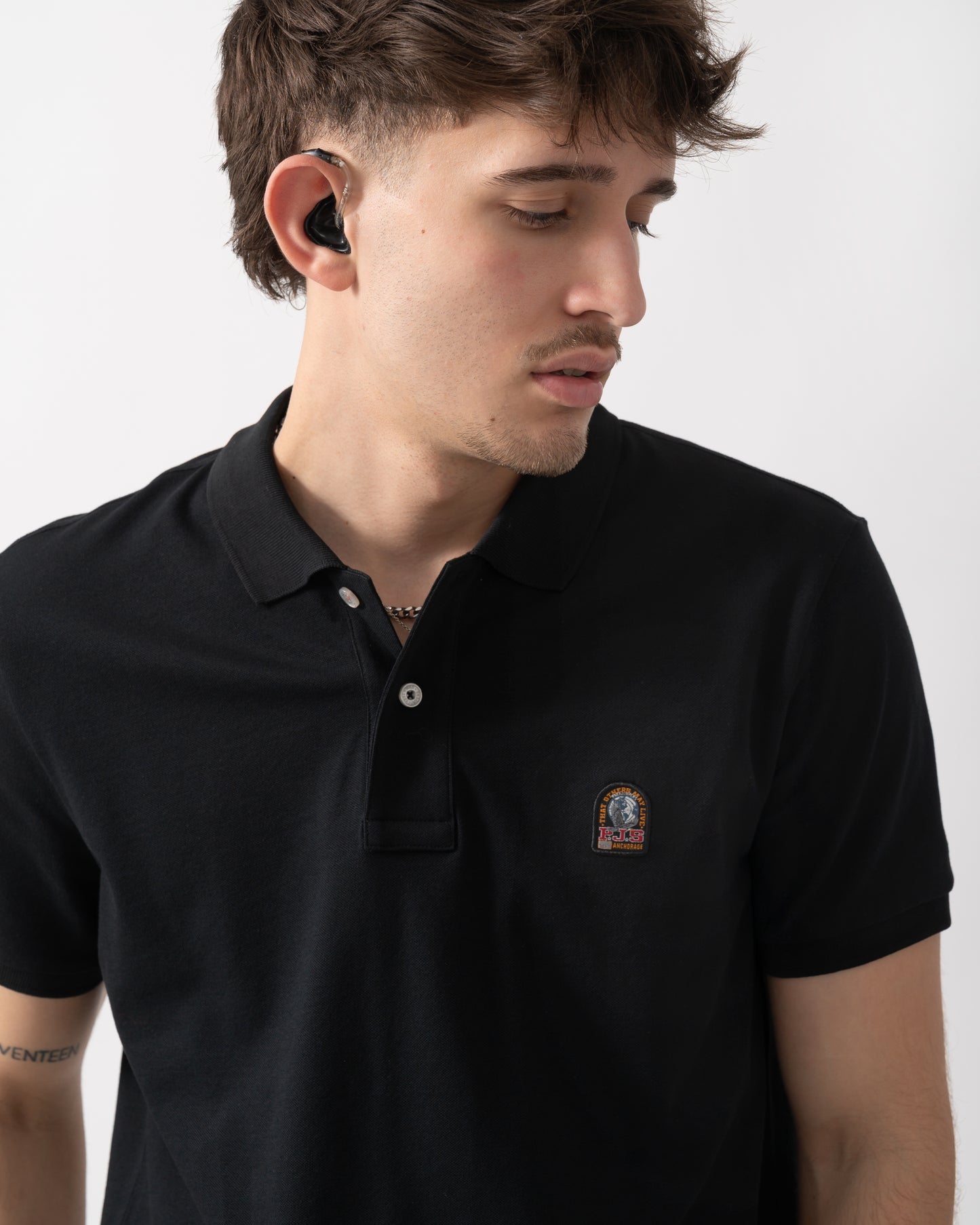 close up shot of a model wearing a Parajumpers Wellington Mens Polo Shirt in Black 541