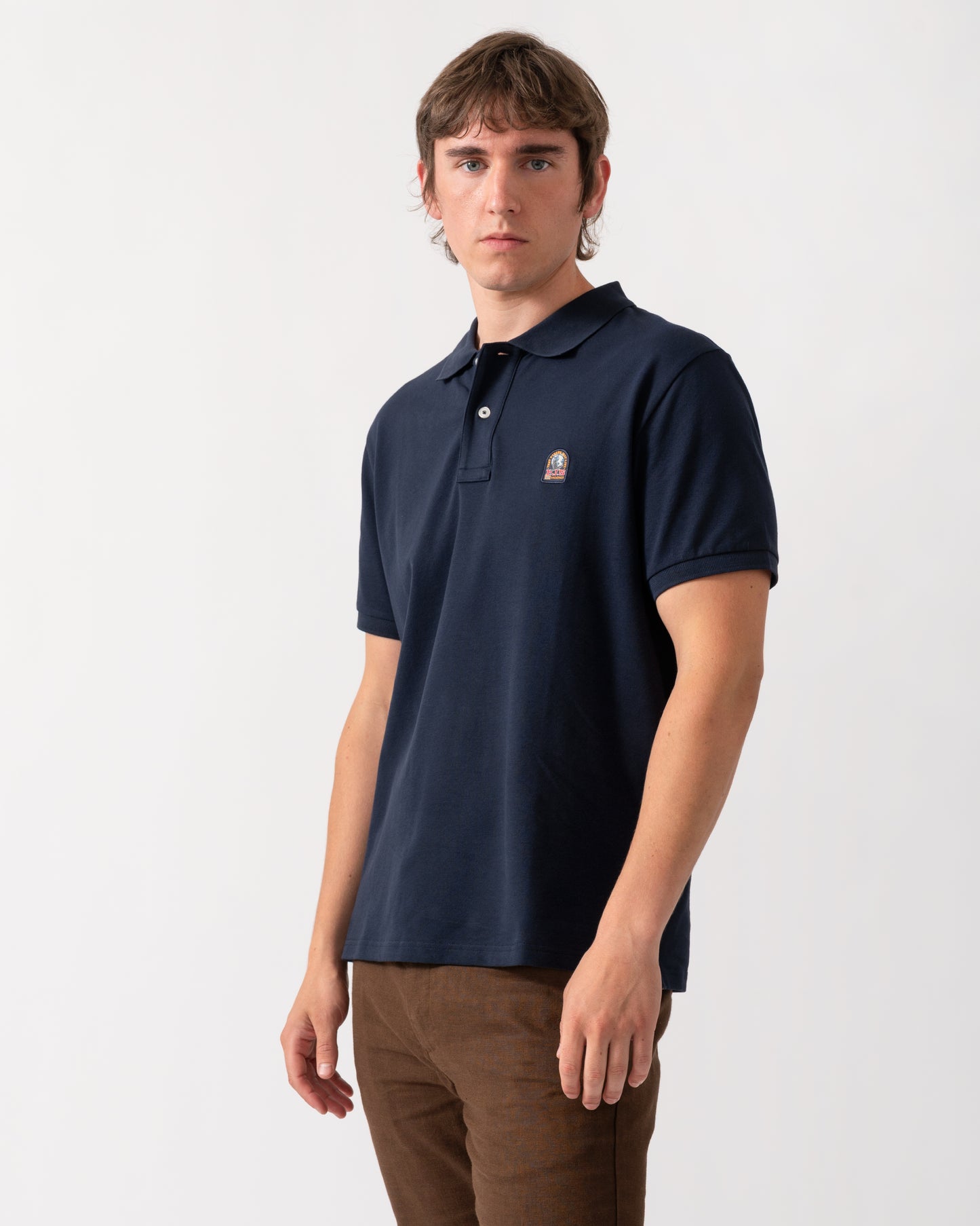 model wearing a Parajumpers Wellington Mens Polo Shirt in Blue Navy 316