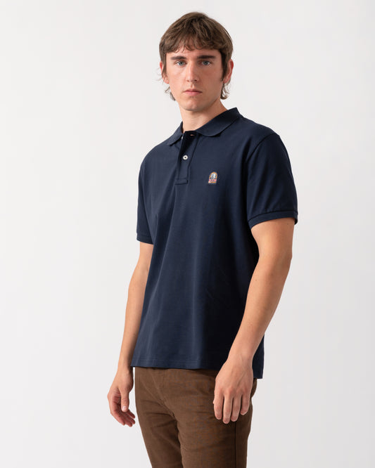 model wearing a Parajumpers Wellington Mens Polo Shirt in Blue Navy 316