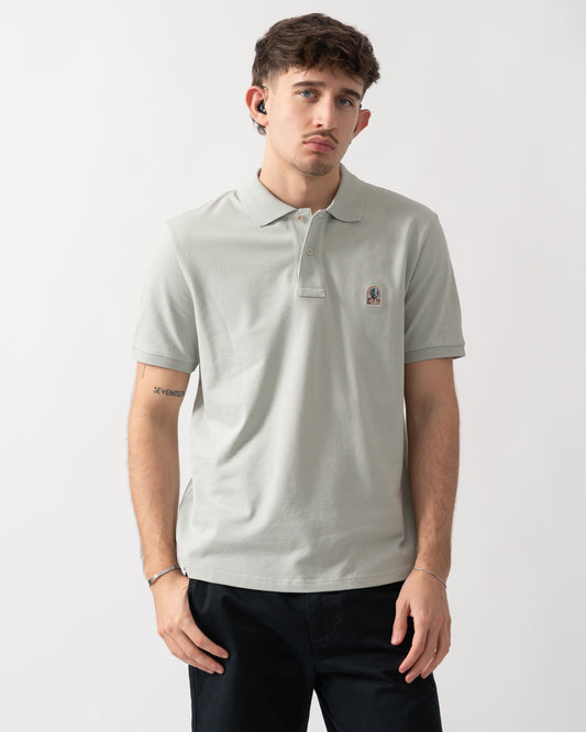 studio shot of a model wearing a Parajumpers Wellington Mens Polo Shirt in Fresh Grey 271