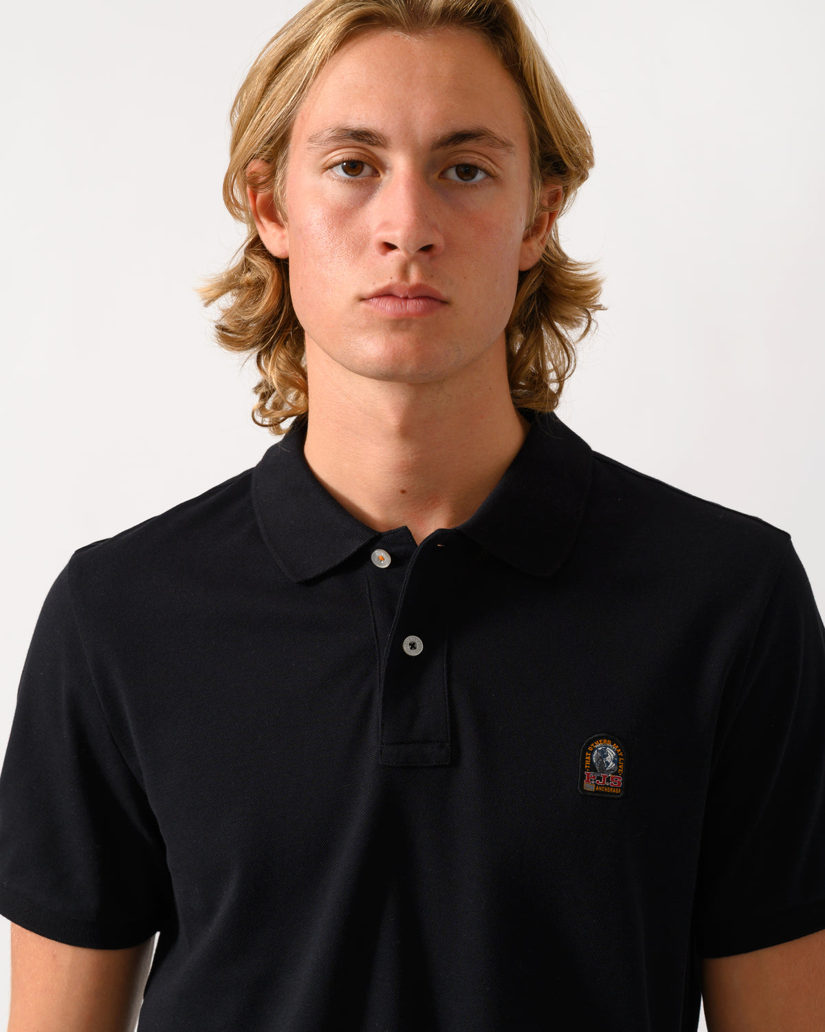 close up of a model wearing Parajumpers Wellington Mens Short Sleeve Polo in Black 541