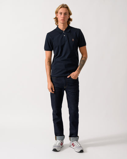full length of a model wearing a Parajumpers Wellington Mens Short Sleeve Polo in Blue Navy 316