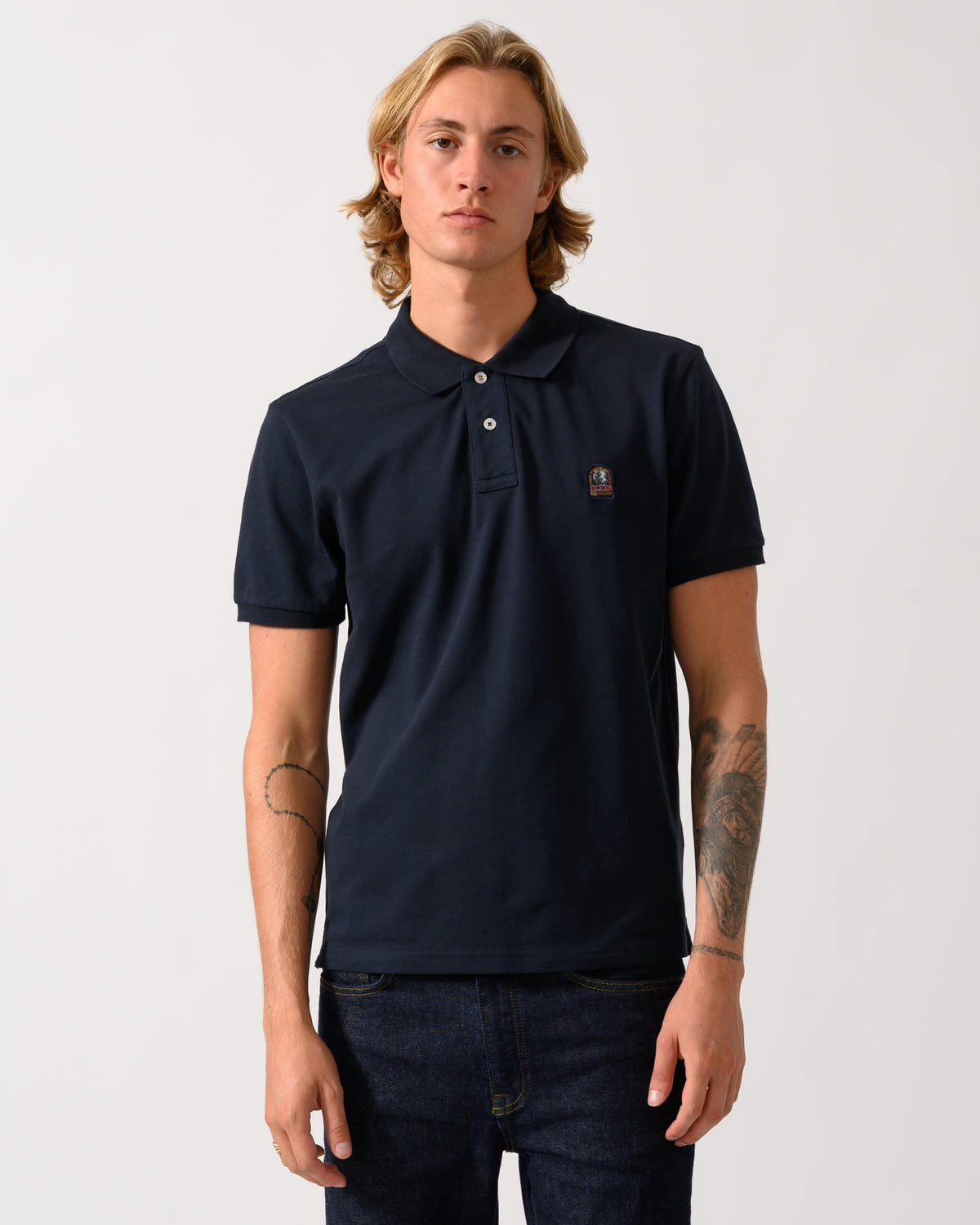 model wearing a Parajumpers Wellington Mens Short Sleeve Polo in Blue Navy 316